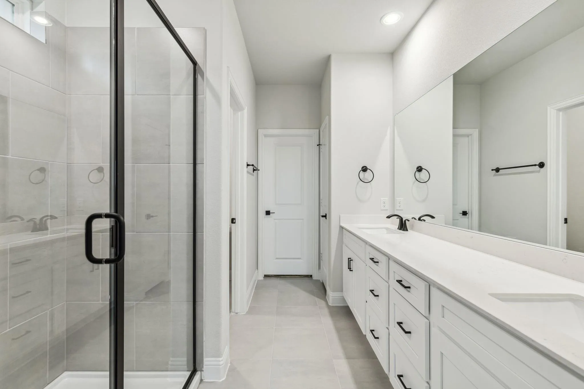 Dual vanity with white cabinetry and integrated sinks
