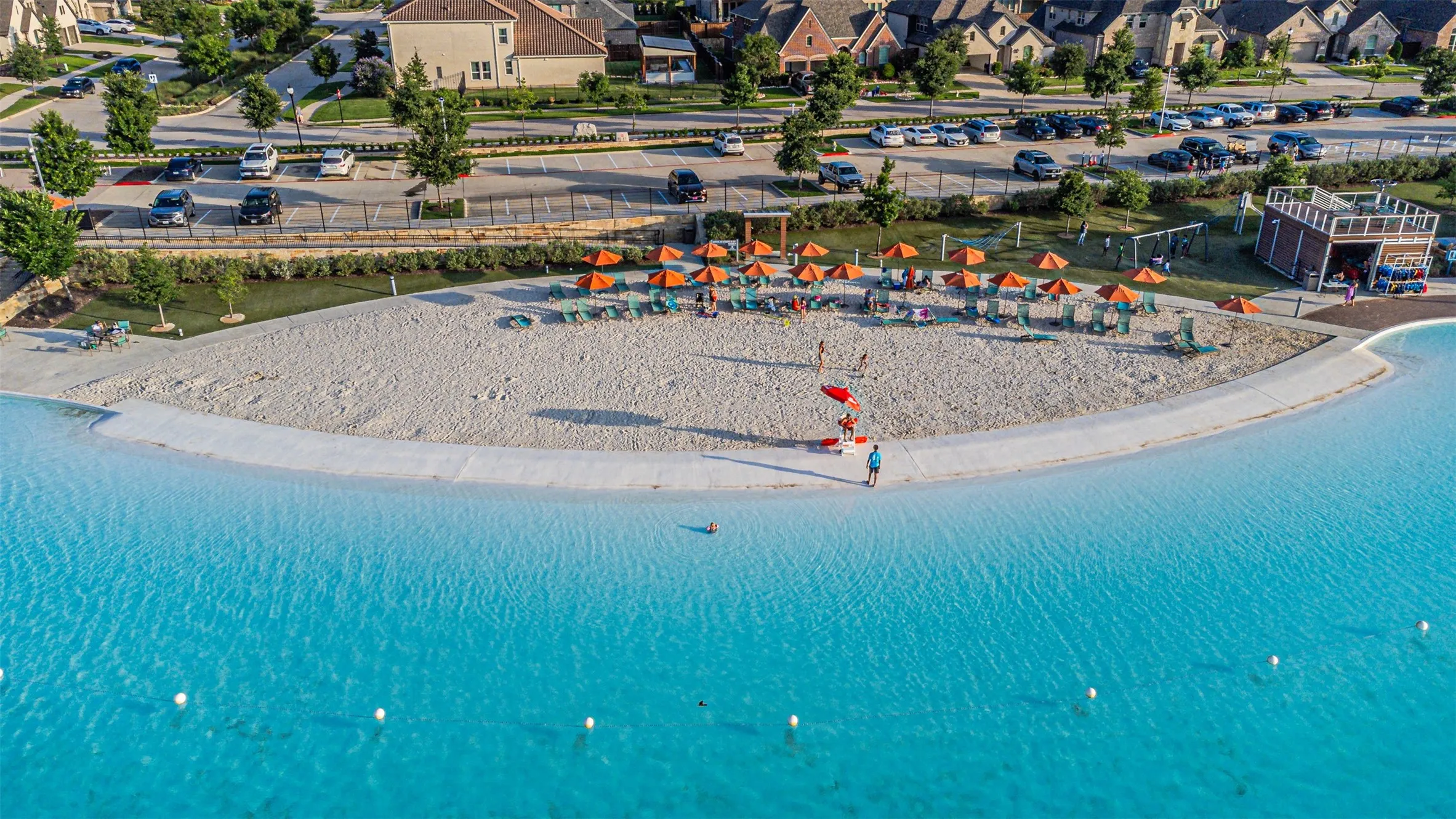 Expansive man-made lagoon with a sandy beach shoreline