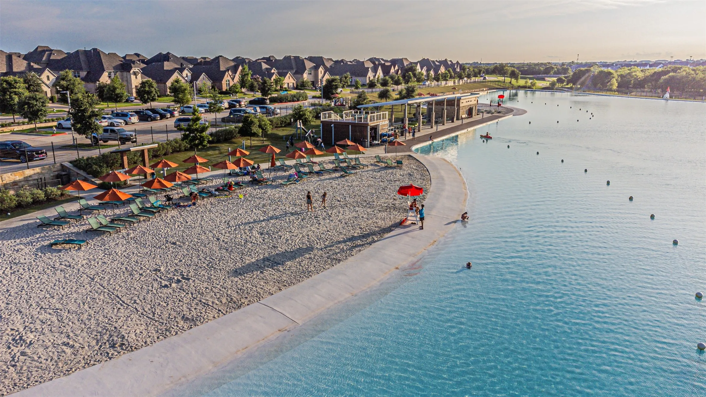Expansive lagoon with a sandy beach and concrete edge