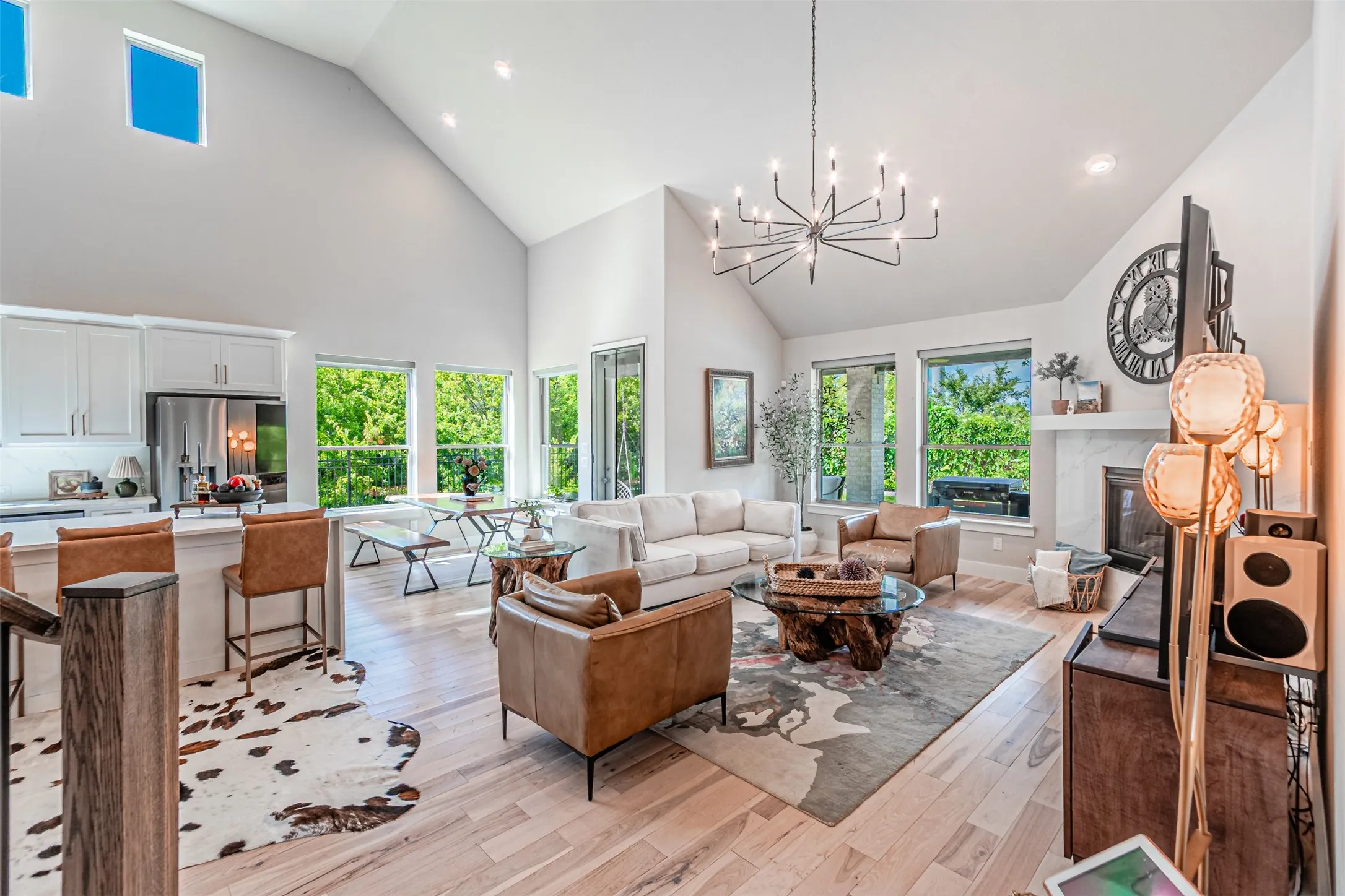 Open-concept living area with vaulted ceilings and wood-finish flooring