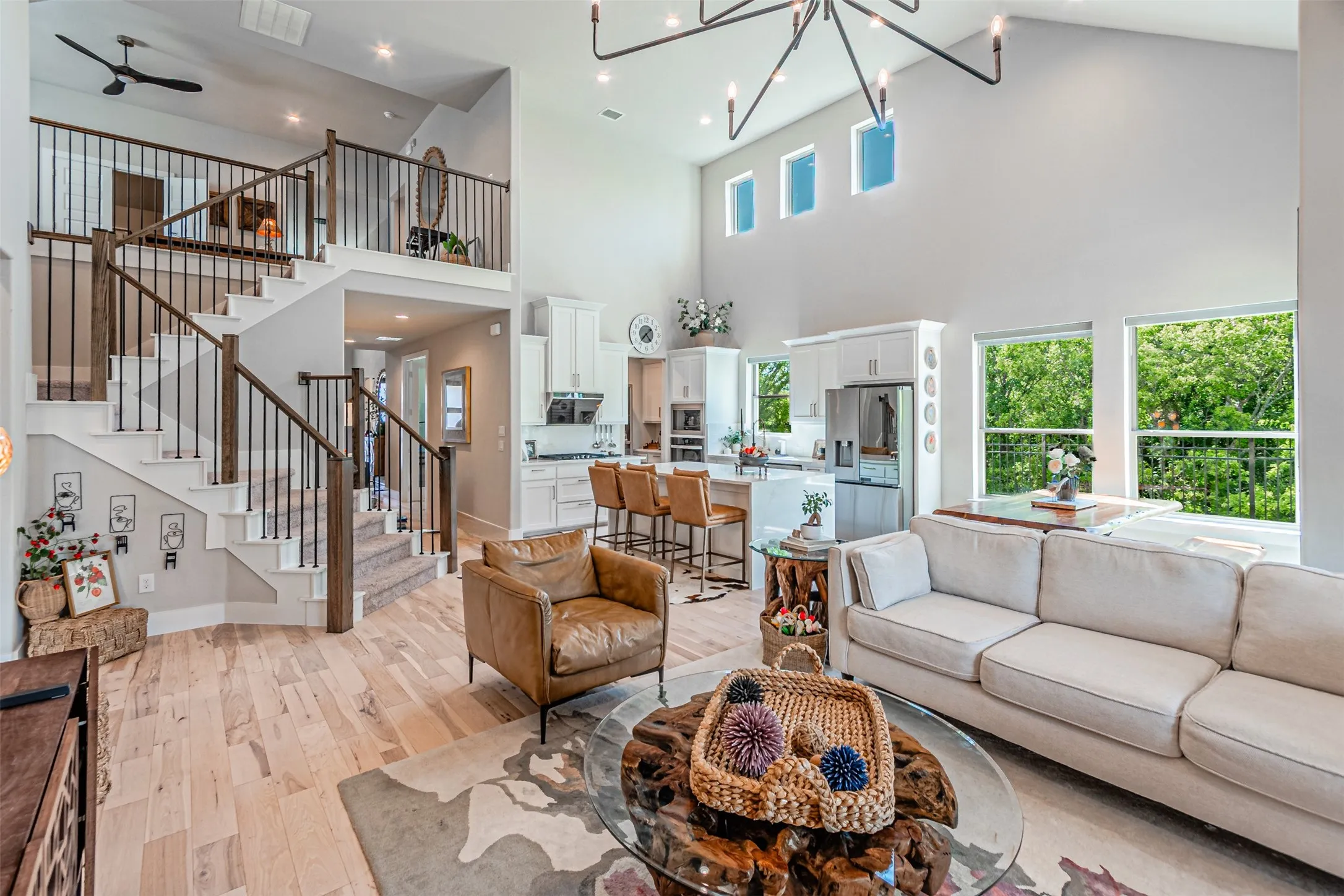 Expansive living area featuring soaring ceilings and wood-finish flooring