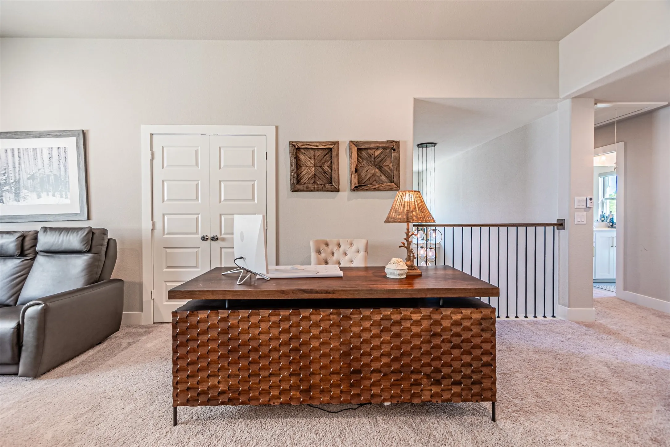 Versatile upper-level space featuring light beige carpeting and white wall finishes