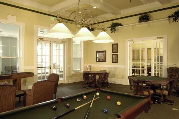 The billiards, poker, and shuffleboard room offers a fun and inviting space for friendly competition, relaxation, and social connection with neighbors and friends.