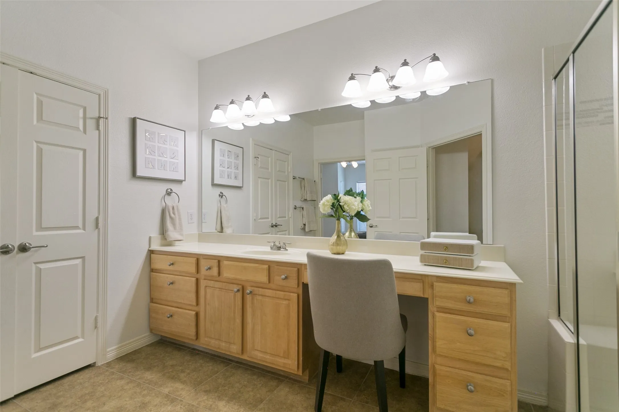 Spacious ensuite primary bathroom featuring an oversized walk-in closet and a dedicated vanity area.