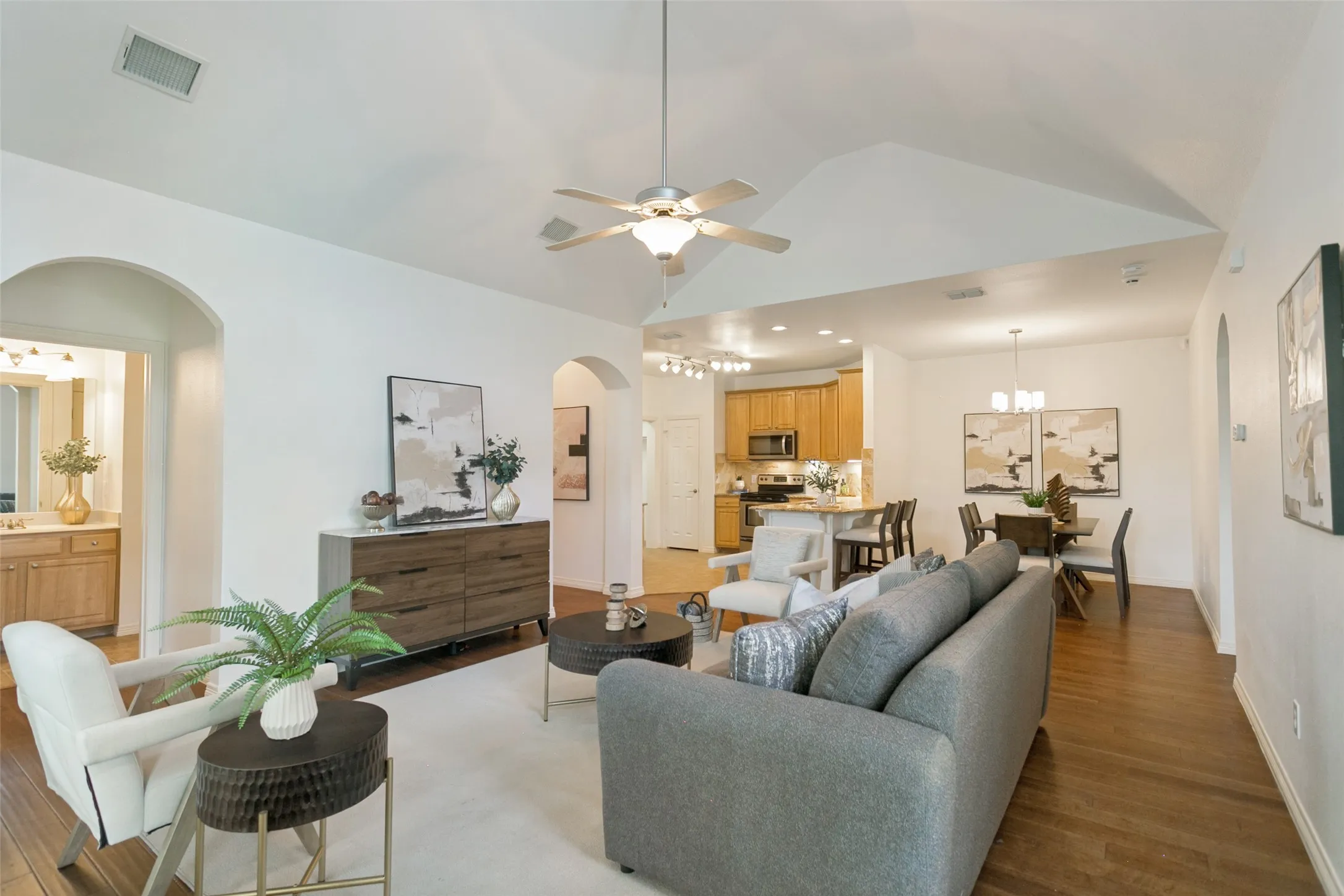 Another stunning view of the open-concept living, dining, kitchen, and entryway spaces, showcasing the seamless flow of the home's inviting design.
