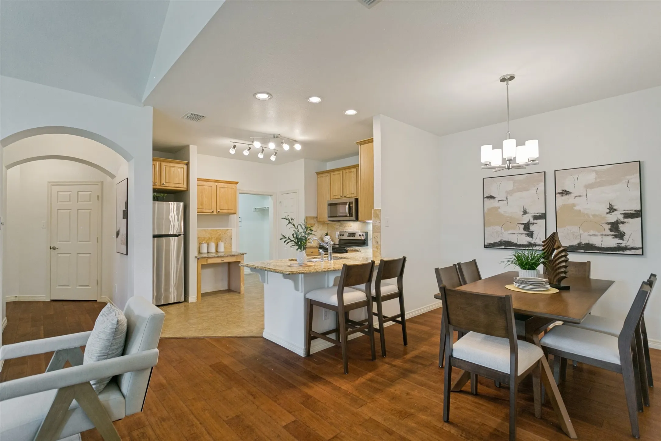 Entryway, spacious hall closet (front door is located to the left of the hall closet), kitchen, utility, and dining room.
