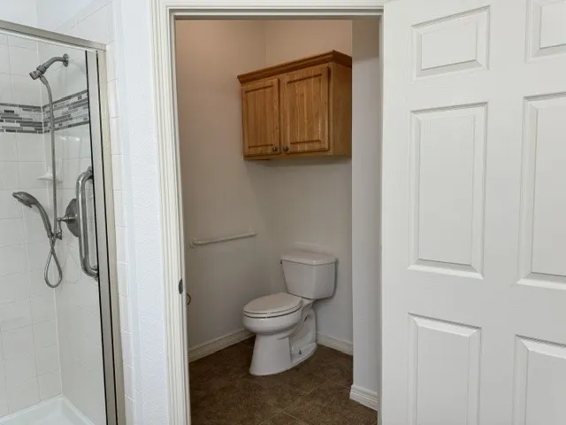 The primary bathroom also features a handicap-accessible shower and a private water closet for added comfort and convenience.