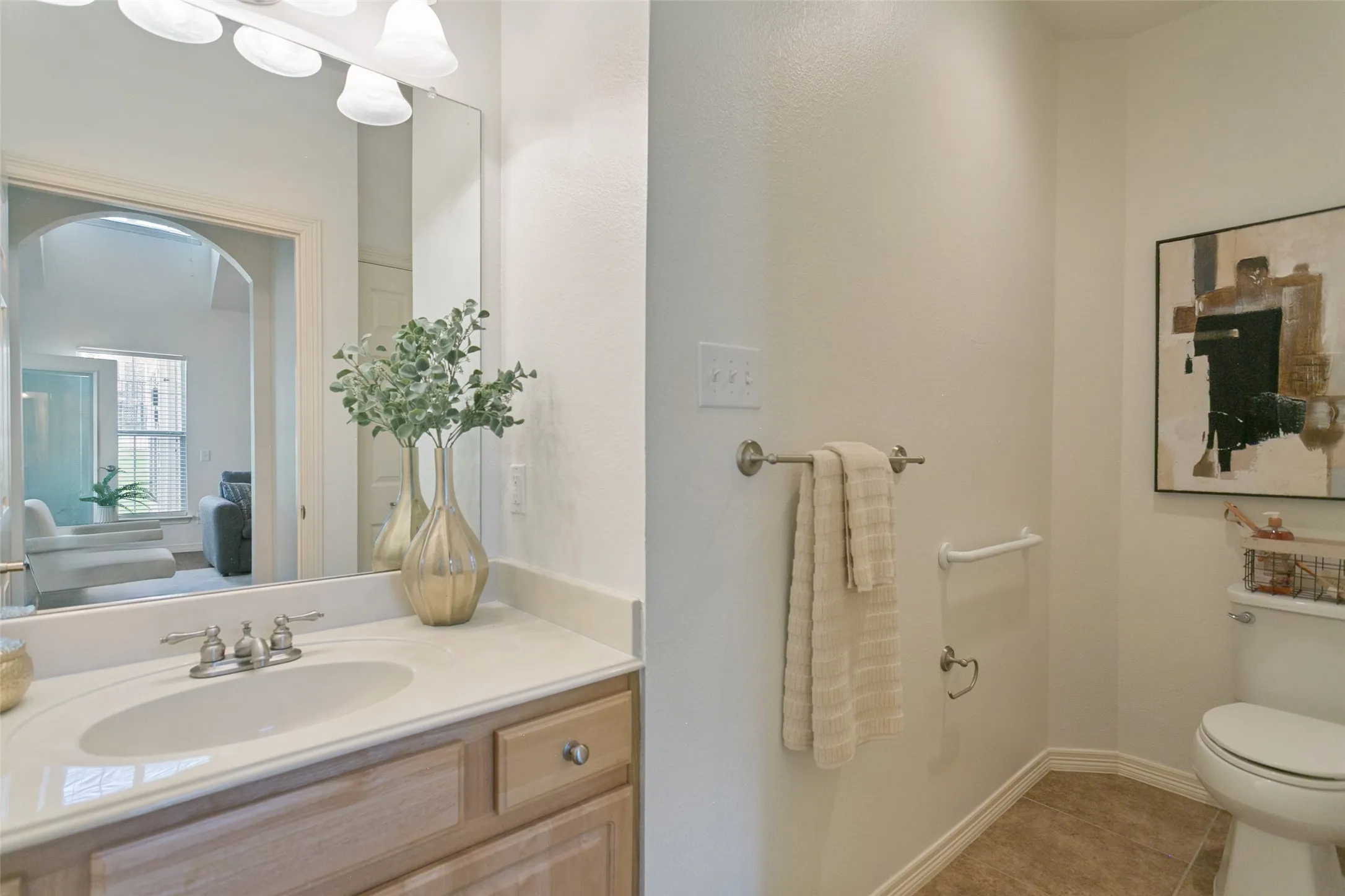 Guest bathroom conveniently located next to the guest bedroom, featuring handicap-accessible features for comfort and ease of use.  Shower and tub combo not shown.