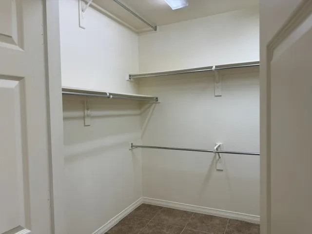 Expansive walk-in closet located within the primary bathroom.