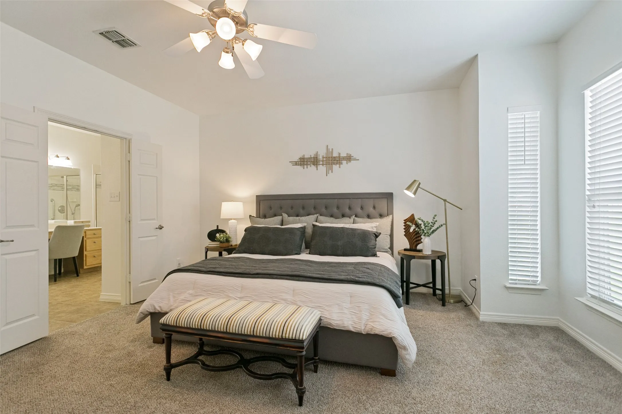 Spacious primary bedroom featuring a comfortable sitting area, creating a relaxing retreat within the home.