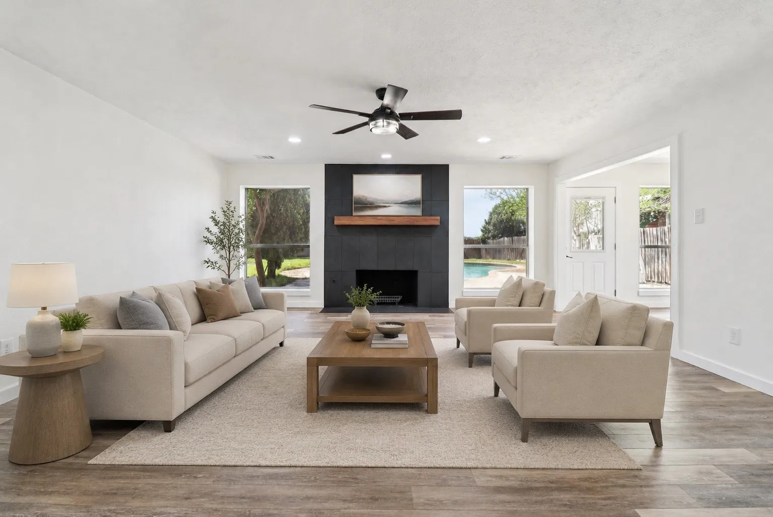 Spacious living room featuring a dramatic floor-to-ceiling fireplace.