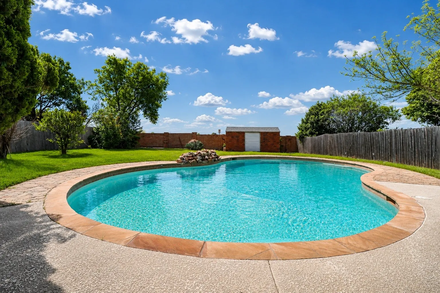 Expansive backyard offering space to relax, play, and entertain.