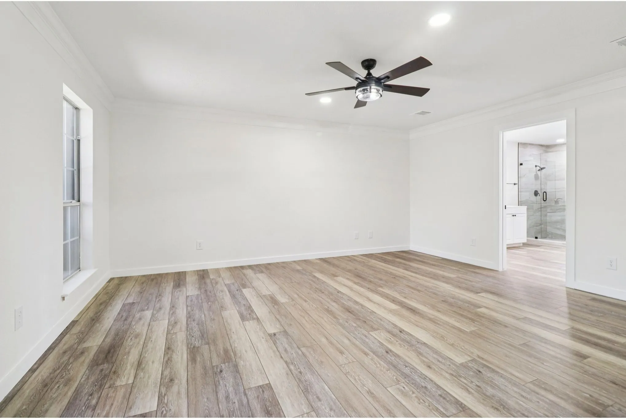 Private downstairs primary suite with generous space and natural light.