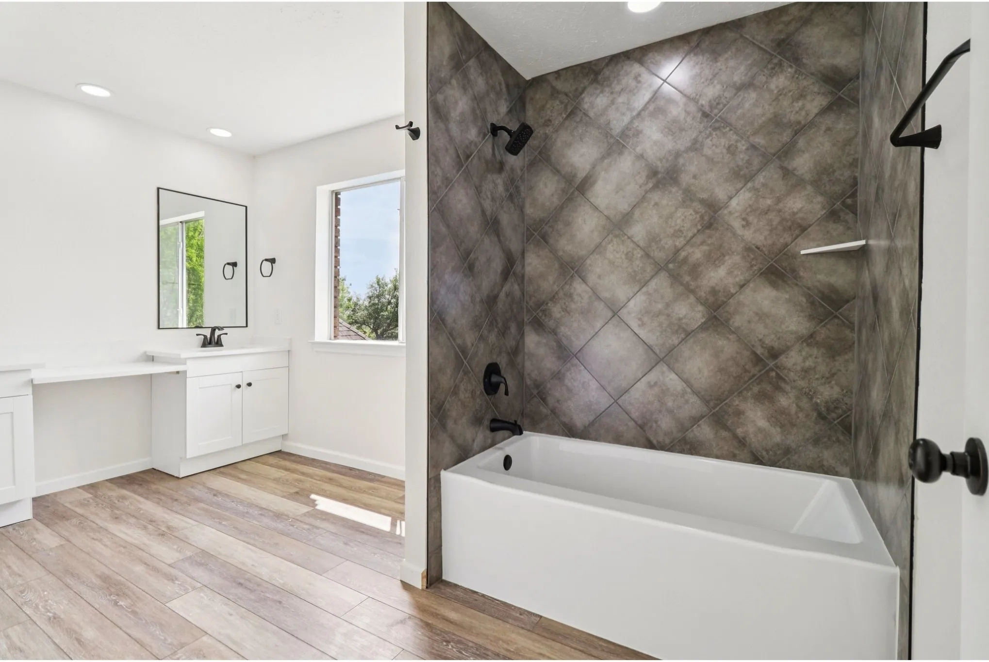 Beautifully updated bathroom with dual vanities and modern finishes.