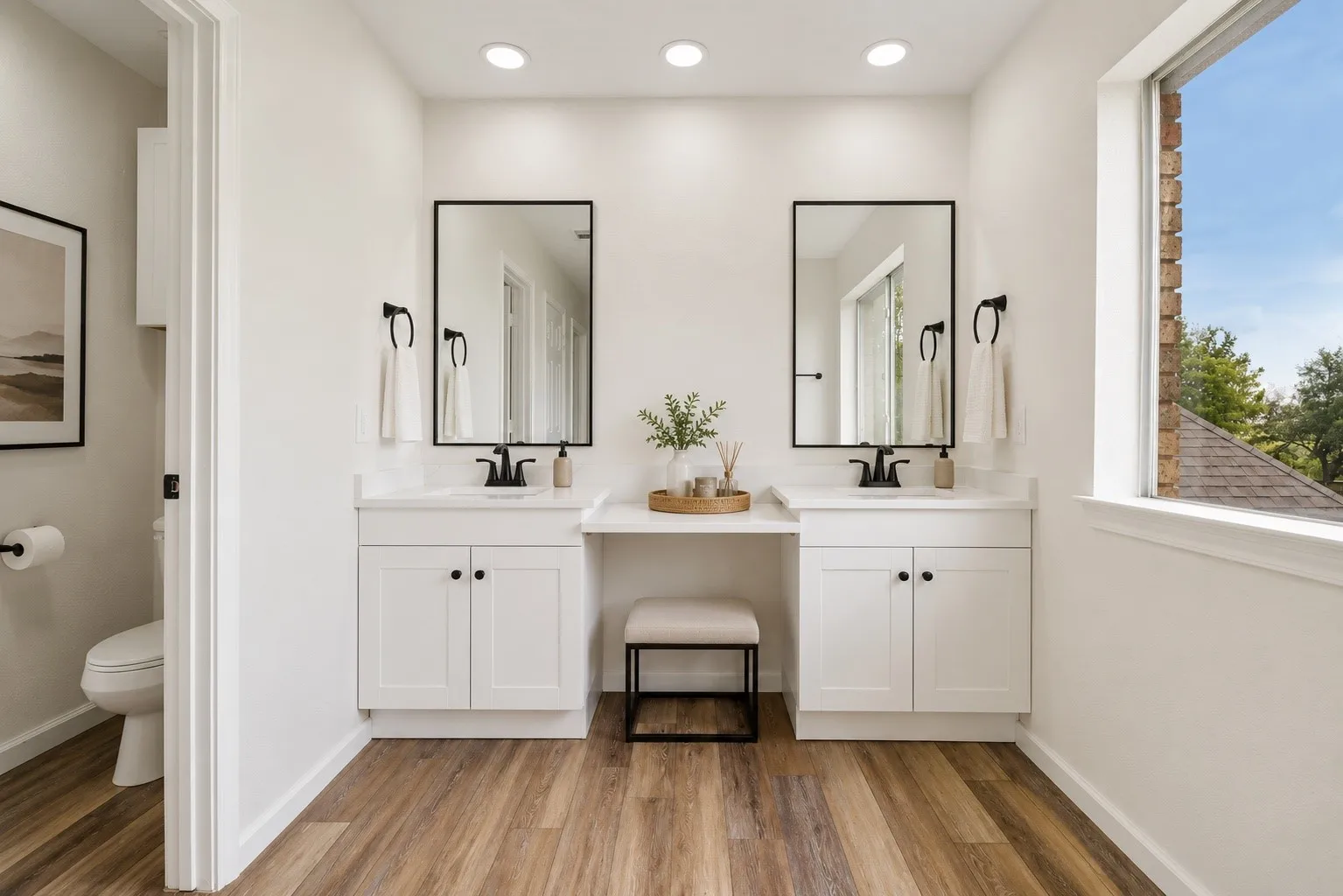 Beautifully updated bathroom with dual vanities and modern finishes.