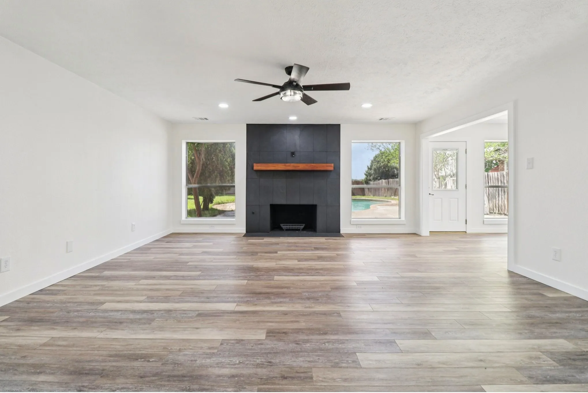 Spacious living room featuring a dramatic floor-to-ceiling fireplace.