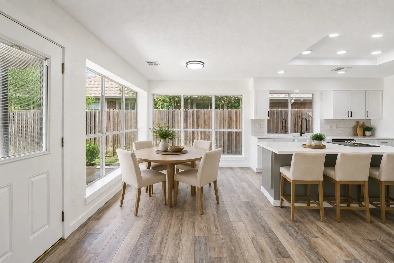 Bright breakfast area with views of the backyard and pool.