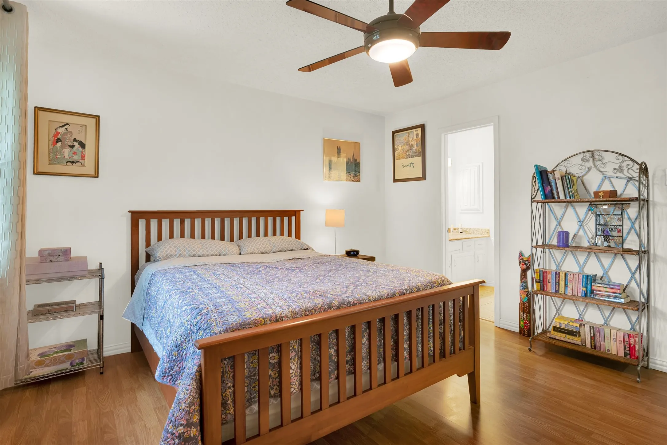 Wood-finish flooring throughout, featuring a ceiling fan with integrated lighting