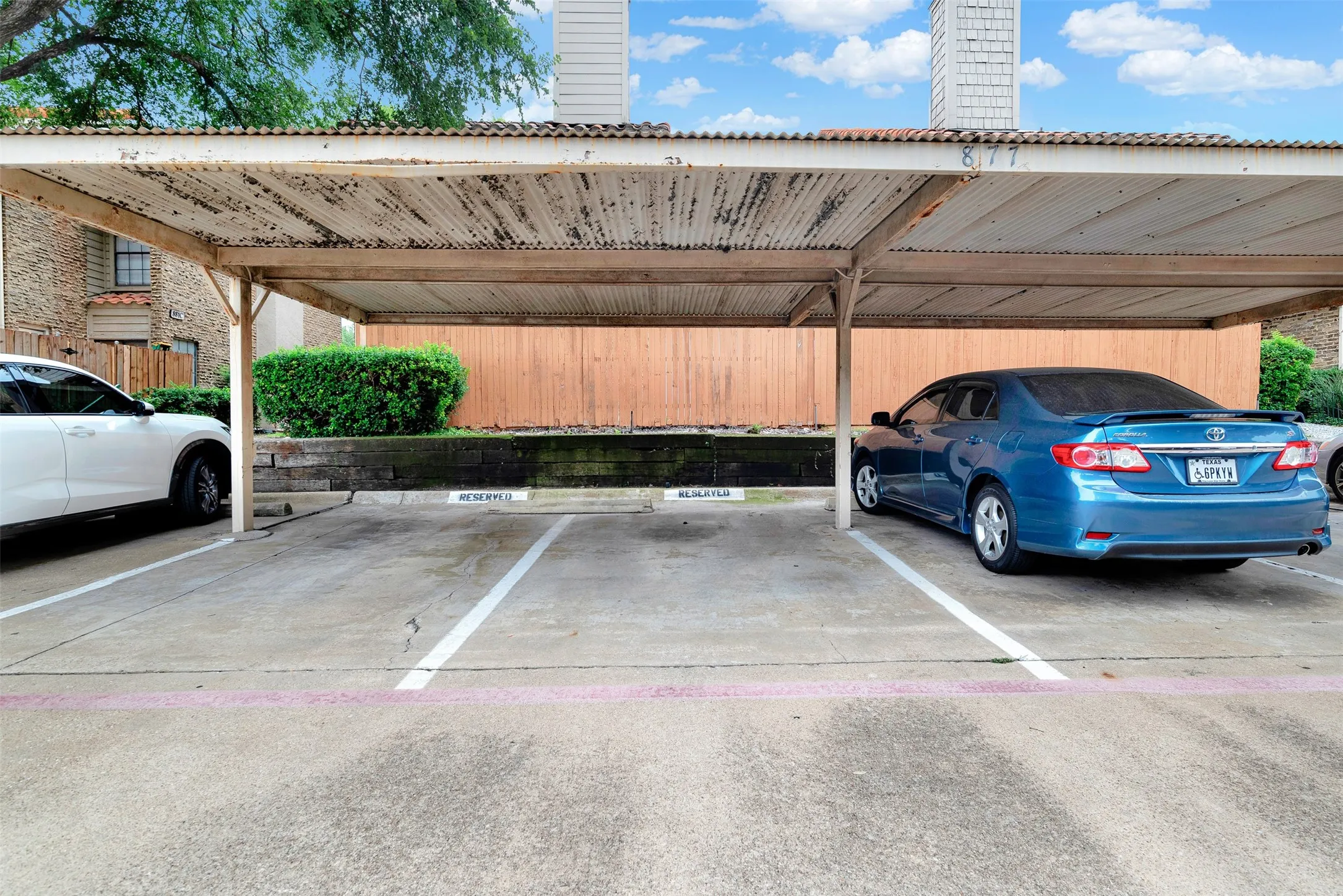 Covered carport parking structure with multiple designated spaces