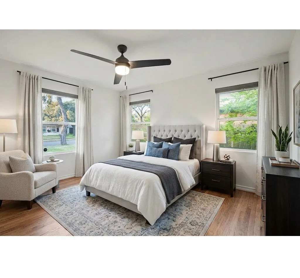 Front bedroom. Hardwood-style flooring complemented by a ceiling fan with integrated lighting. Room has been virtually staged.