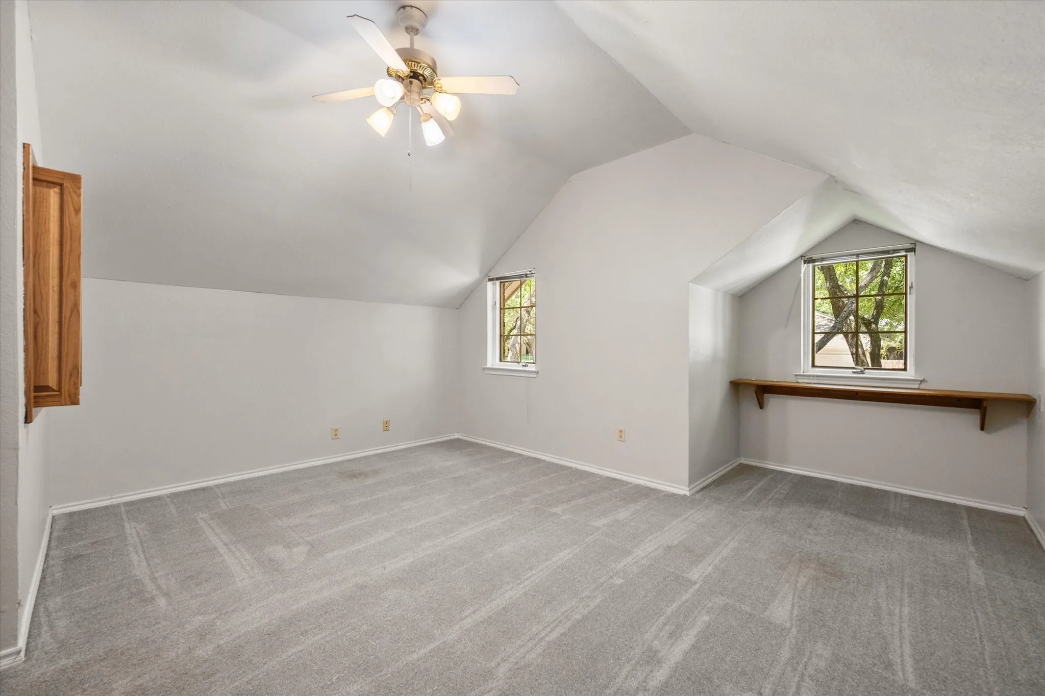 2nd floor bedroom with built-in media shelving and desk