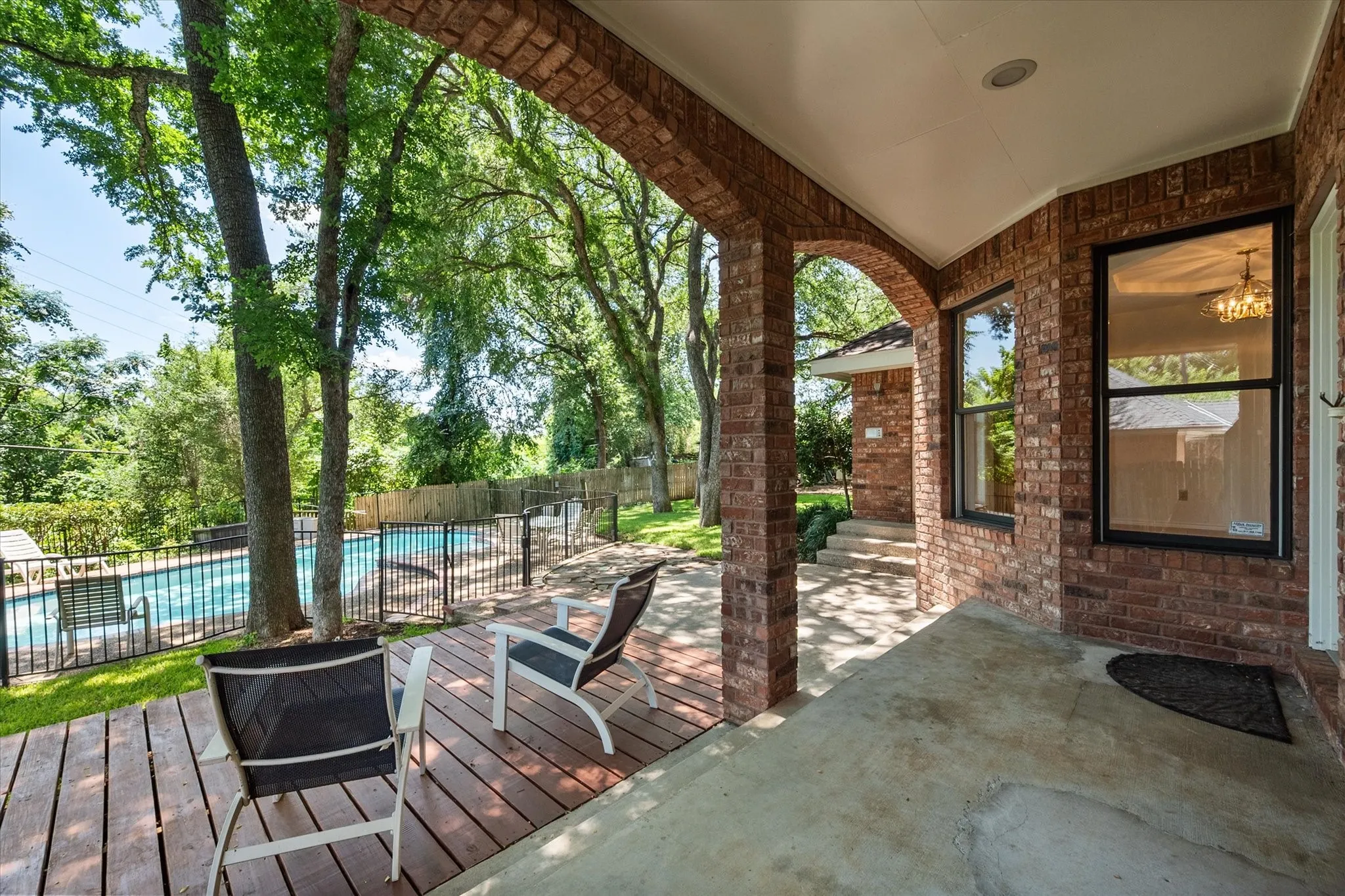 Amazing covered porch overlooking the yard and pool