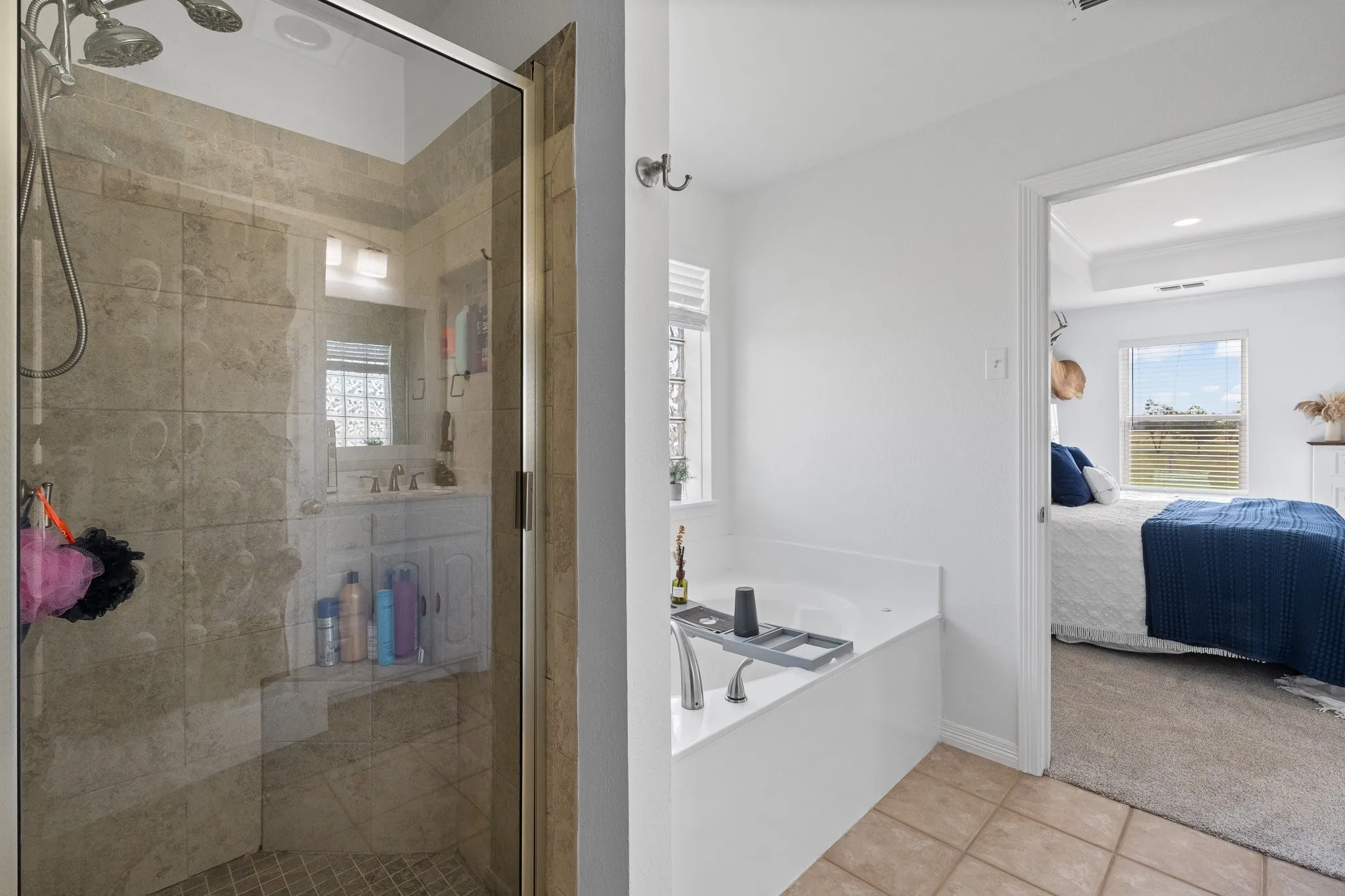 Bathroom featuring a glass-enclosed shower with tile surround and a built-in bench