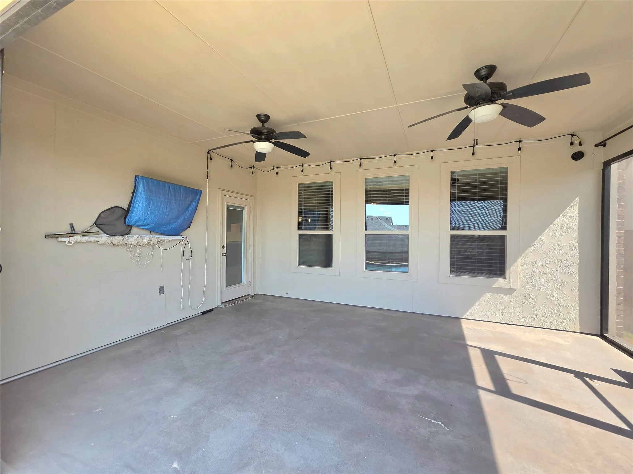 screened in porch, tv, and ceiling fans