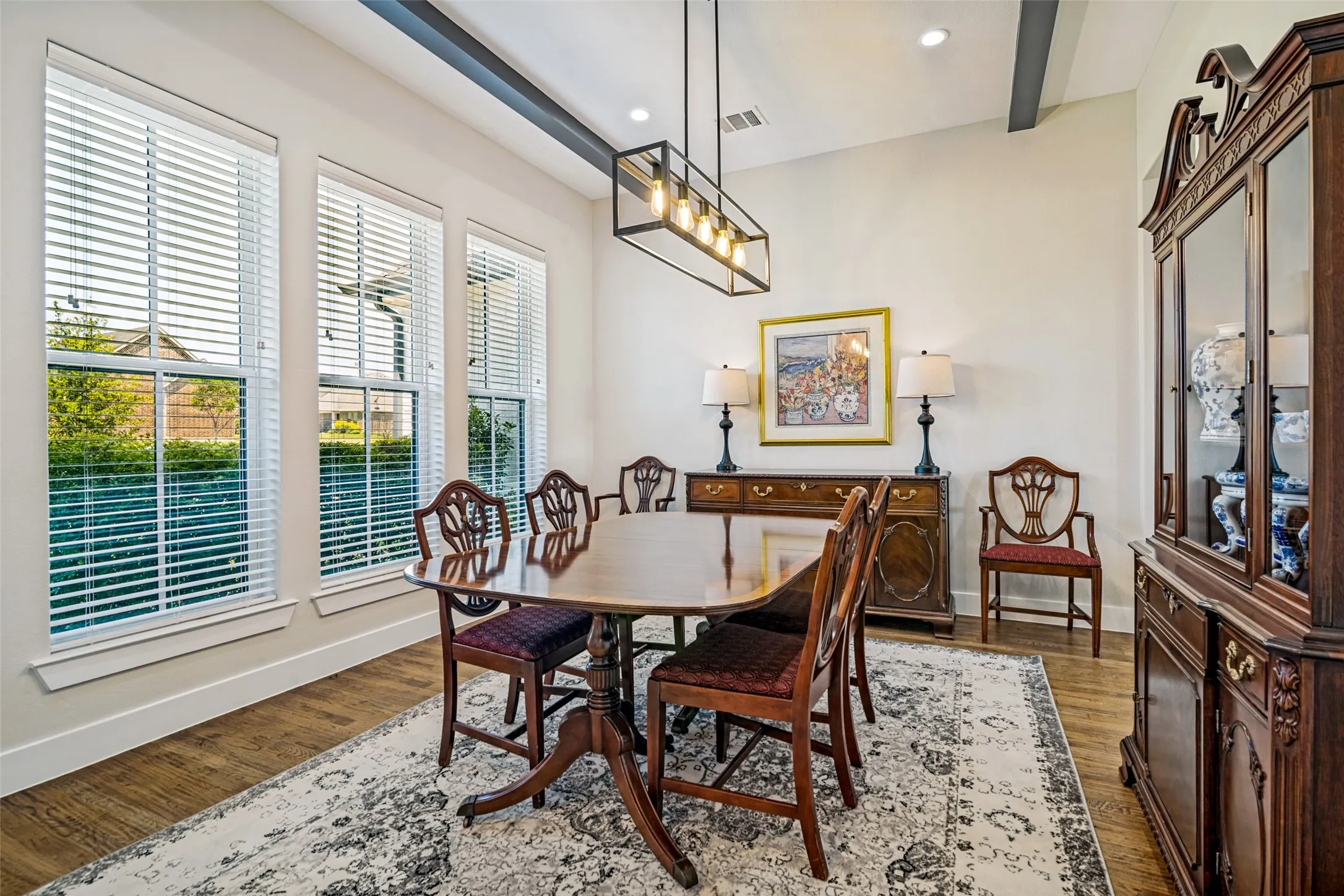 A generous, light-filled dining room with beamed ceiling.