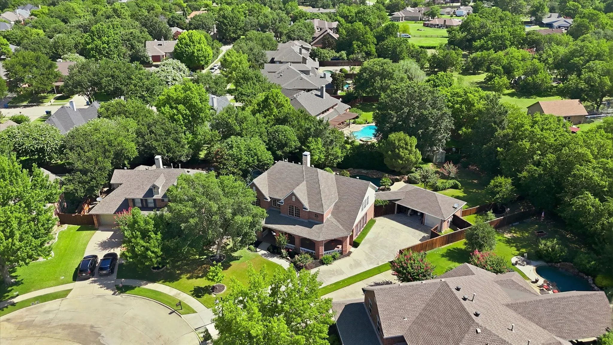 Aerial perspective showcasing the property and its exterior with community mature tree coverage