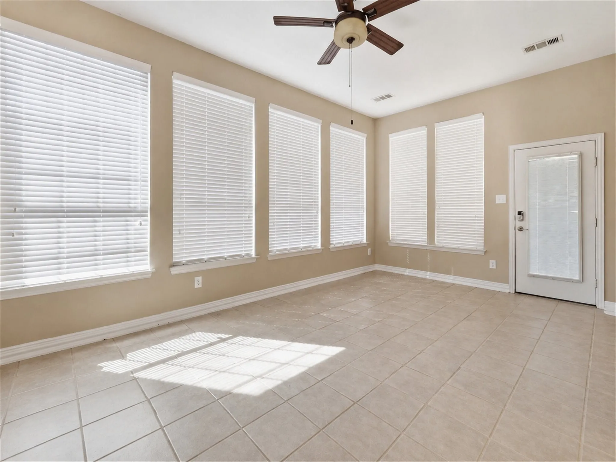 Neutral-toned walls complement the light-colored tile flooring