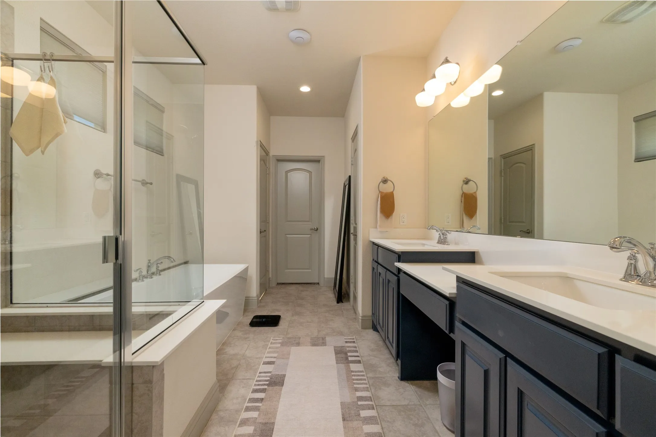 Separate shower, separate vanities, garden tub and linen closet enhance the primary bath