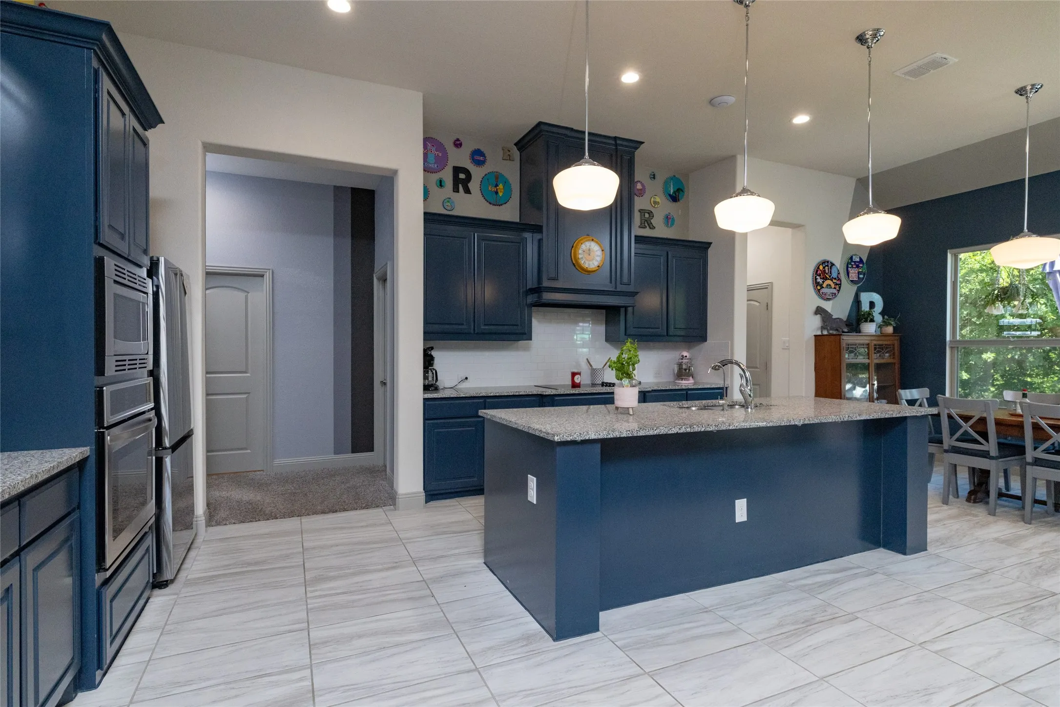 Open concept kitchen with large center island, breakfast bar