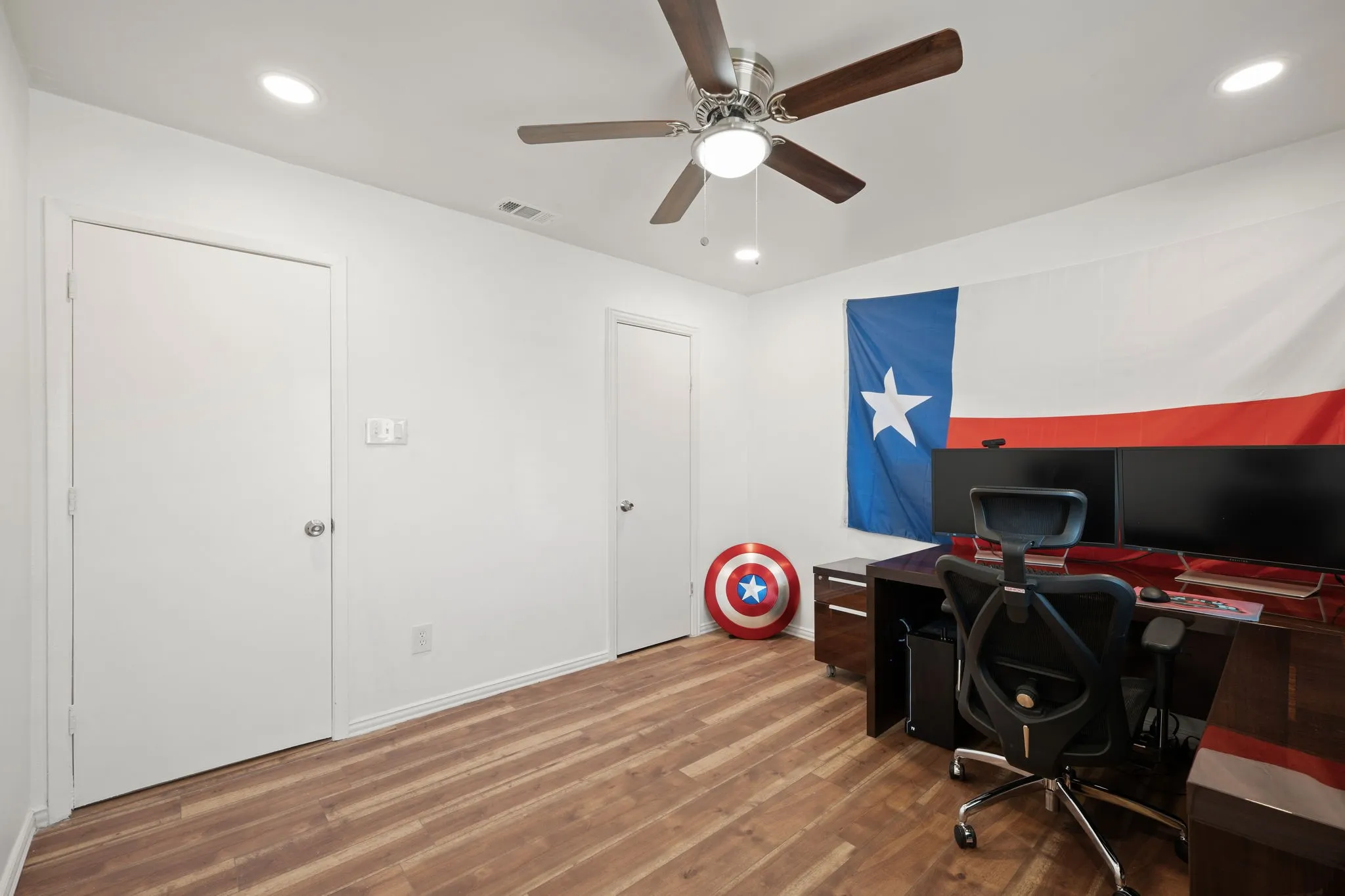 Room featuring wood-finish flooring, recessed lighting, and a ceiling fan with integrated light