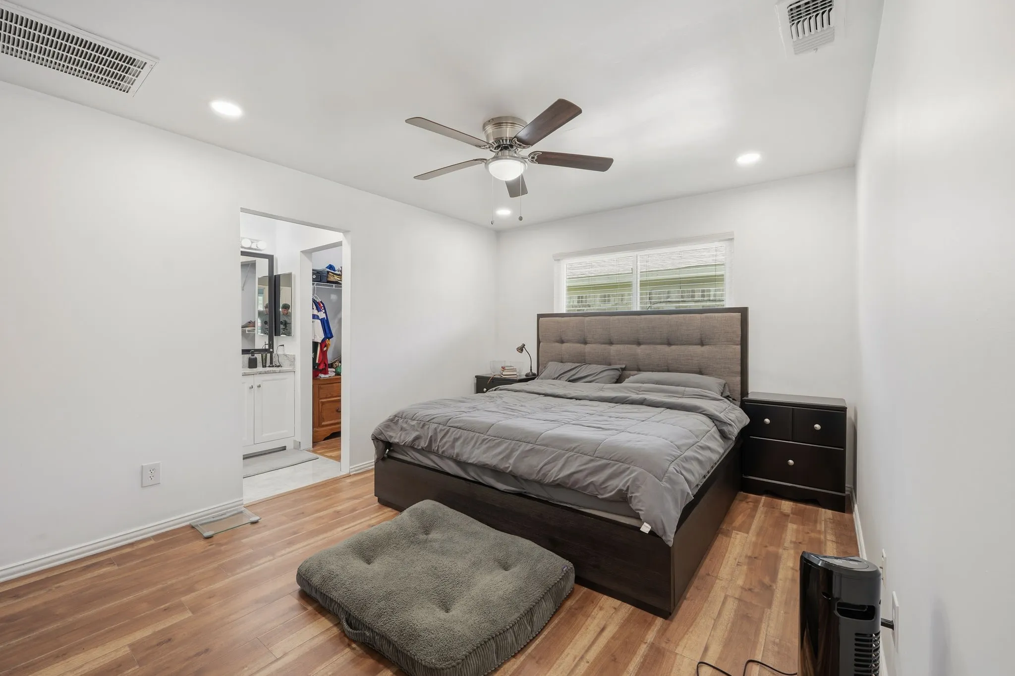 Spacious room featuring wood-finish flooring, recessed lighting, and a ceiling fan