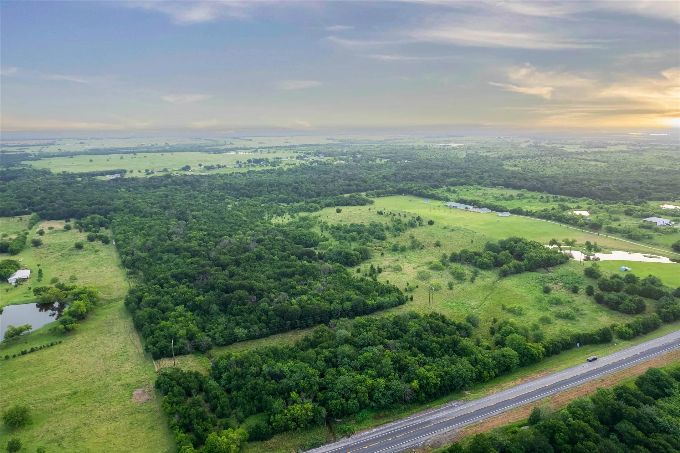 Expansive acreage featuring abundant mature trees and open grassy areas