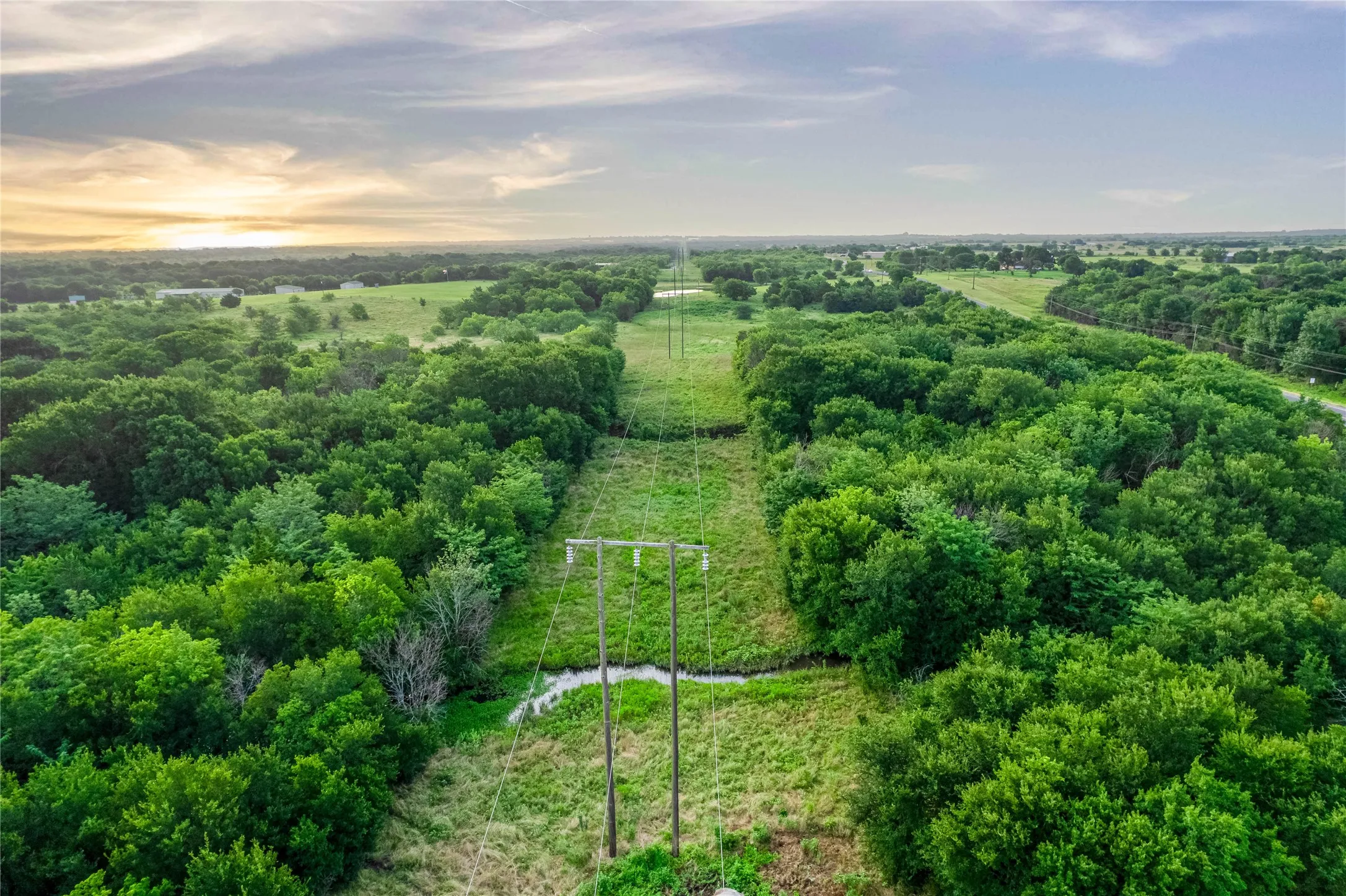 Expansive acreage featuring mature trees and open grassy areas