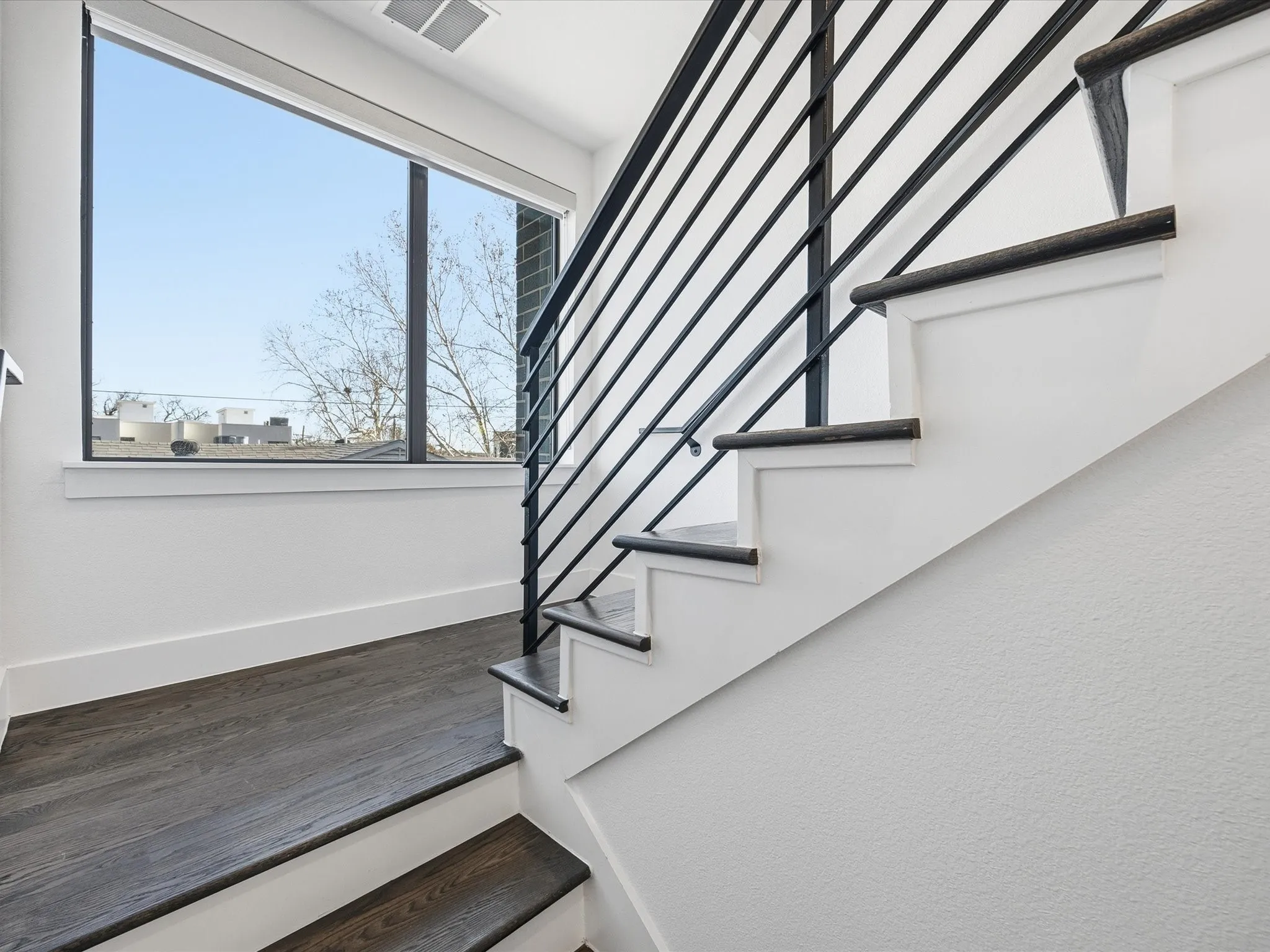 Staircase with baseboards and wood finished floors