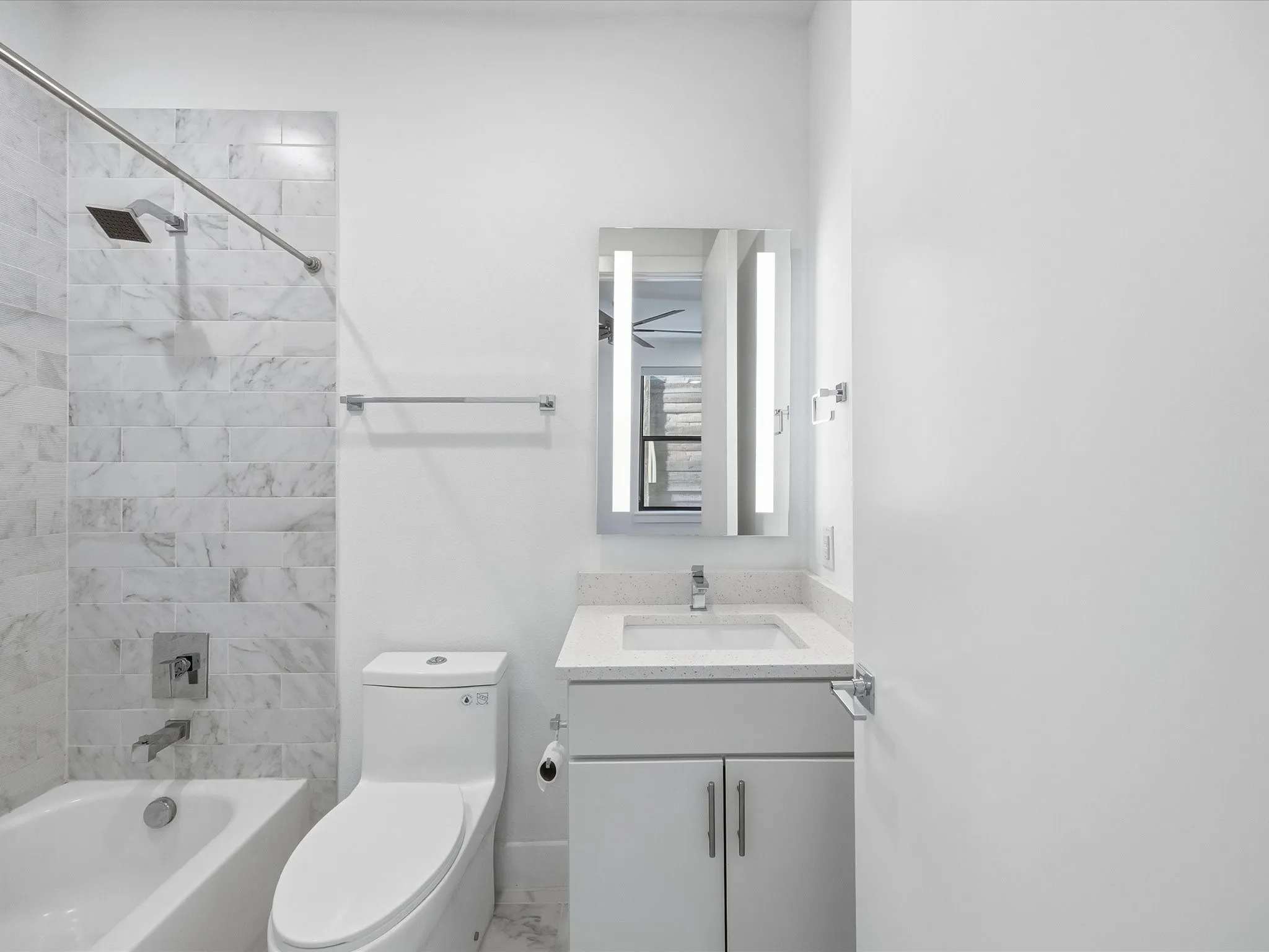 Bathroom with bathtub / shower combination, vanity, and marble finish flooring