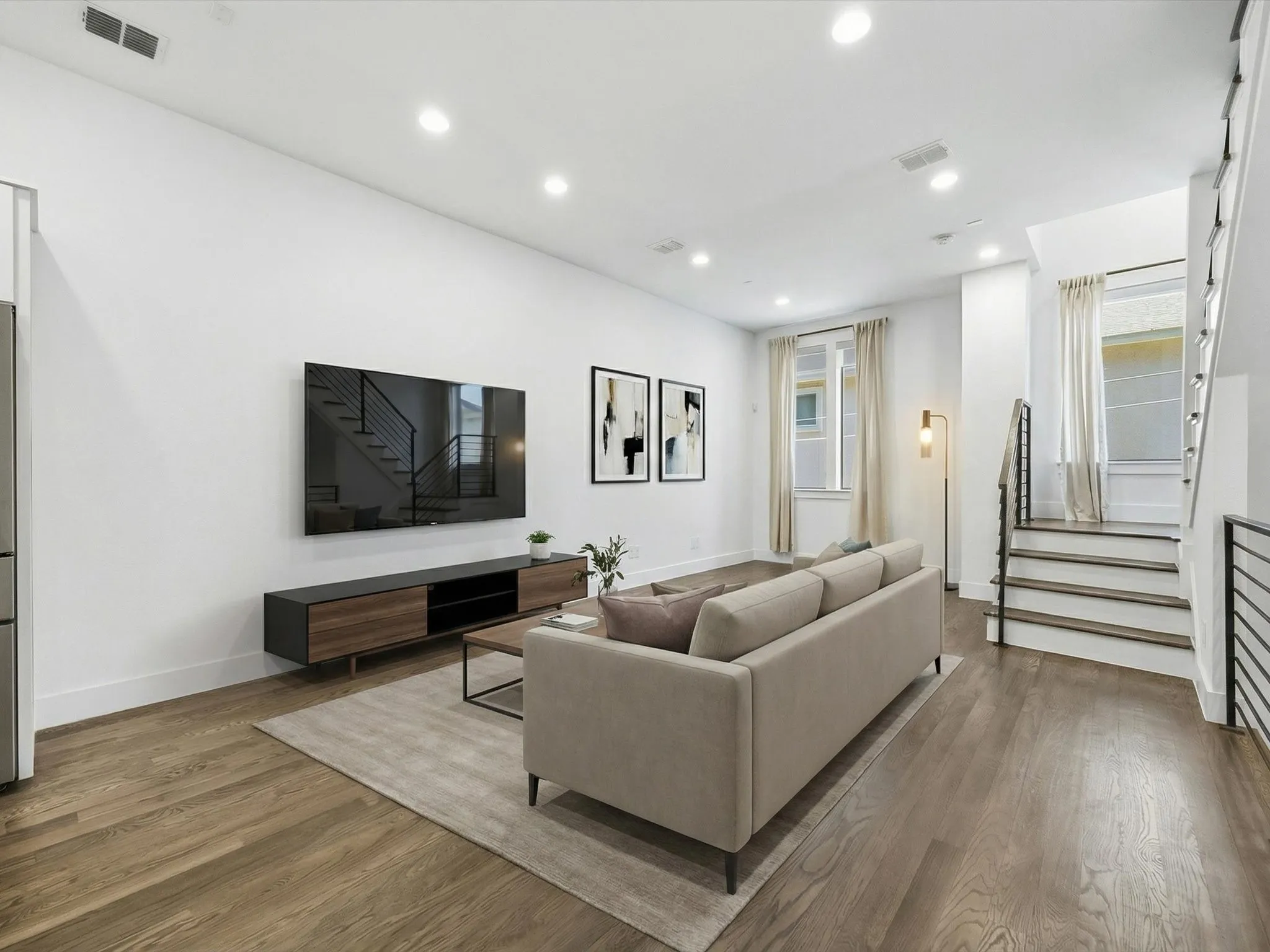Living area featuring light wood-style flooring and recessed lighting