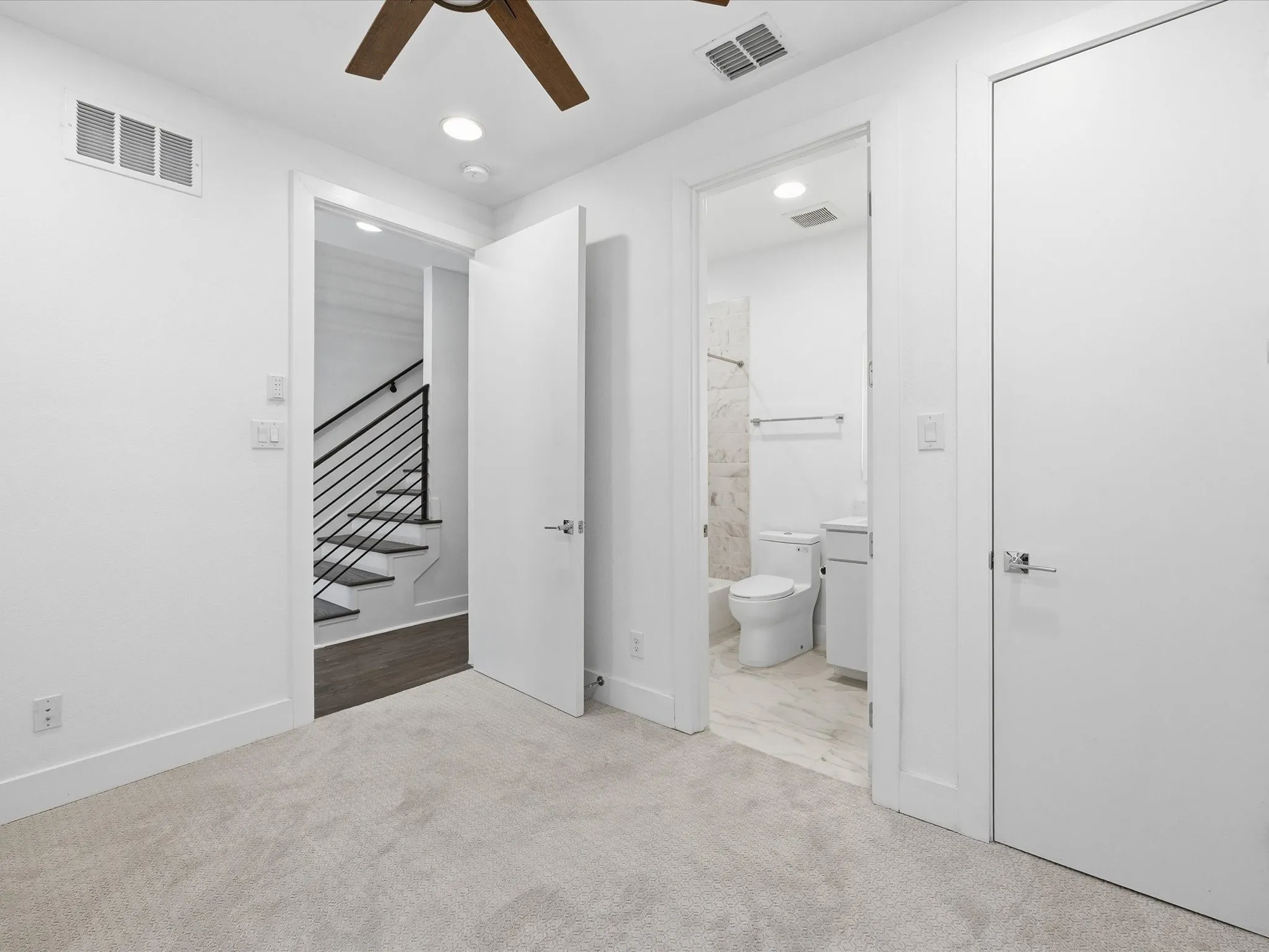 Unfurnished bedroom with ceiling fan, light colored carpet, recessed lighting, and ensuite bath