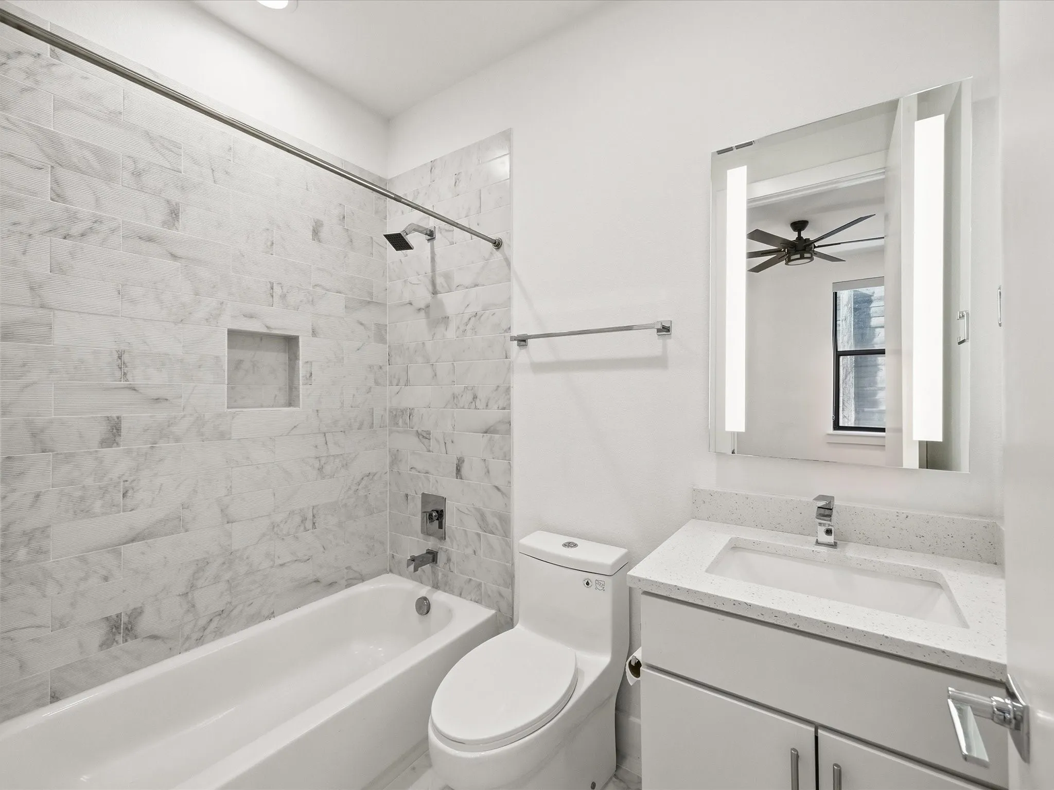Full bath featuring vanity, washtub / shower combination, ceiling fan, and recessed lighting