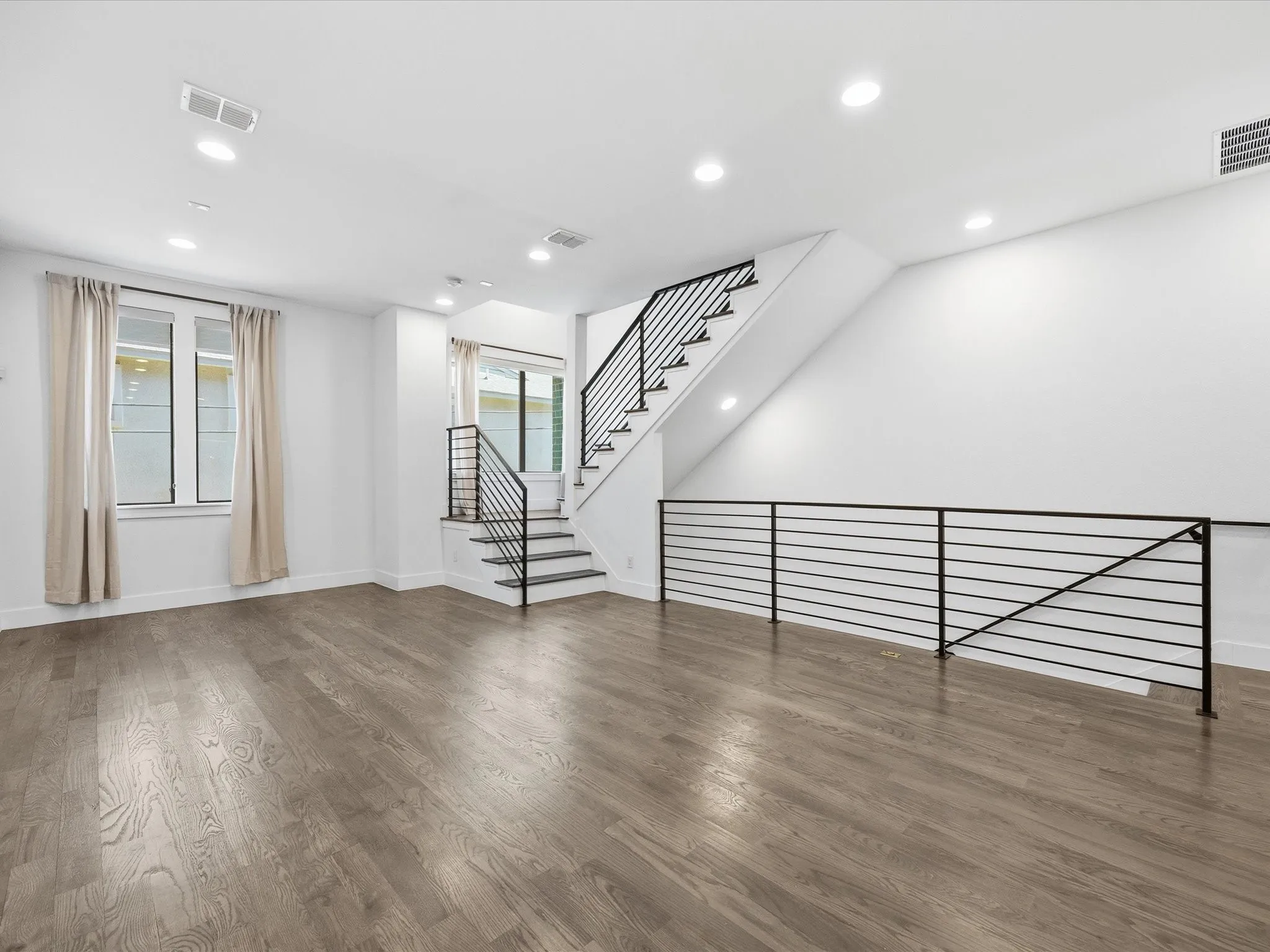 Unfurnished living room featuring recessed lighting and wood finished floors