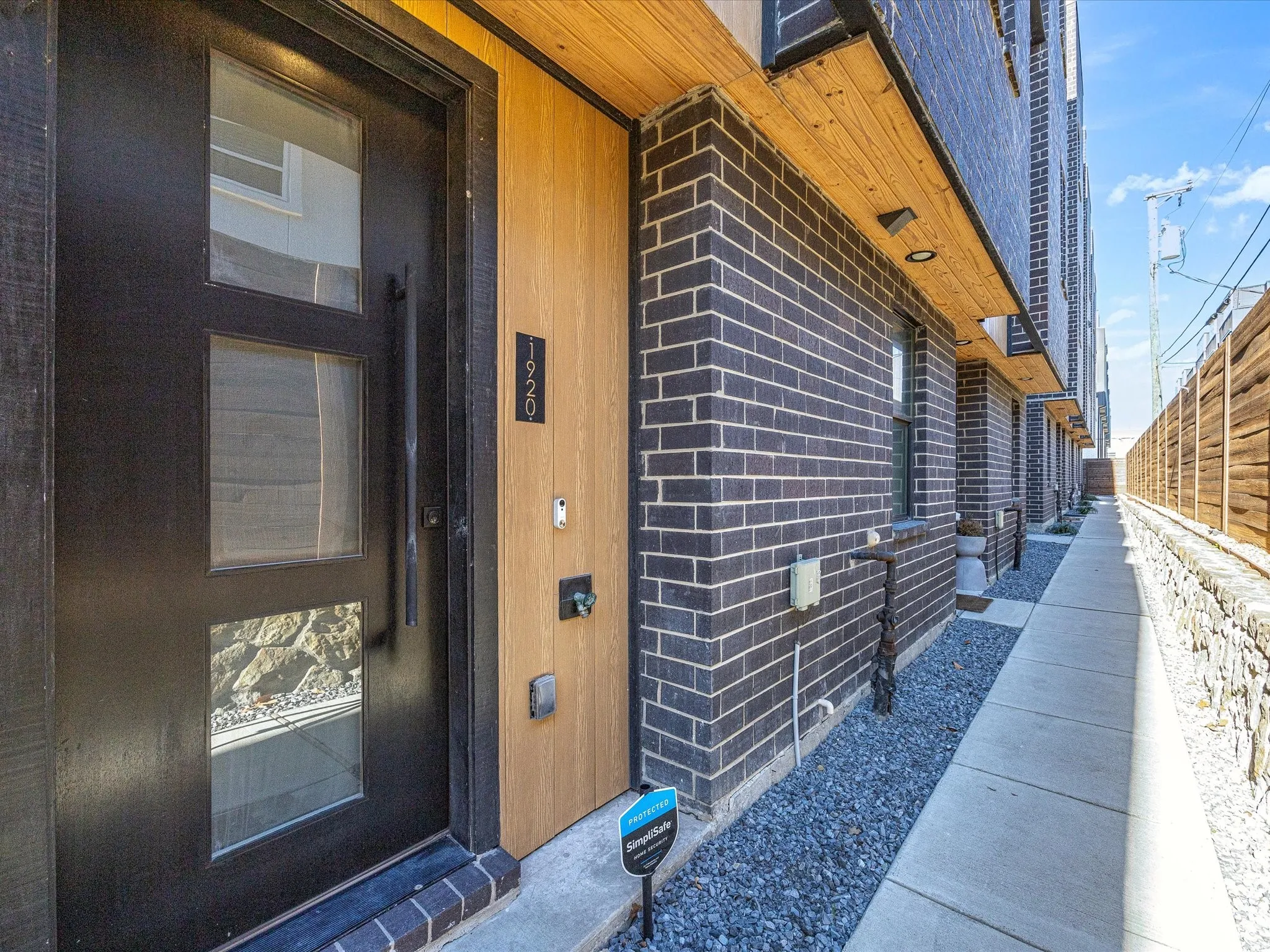 Property entrance featuring brick siding