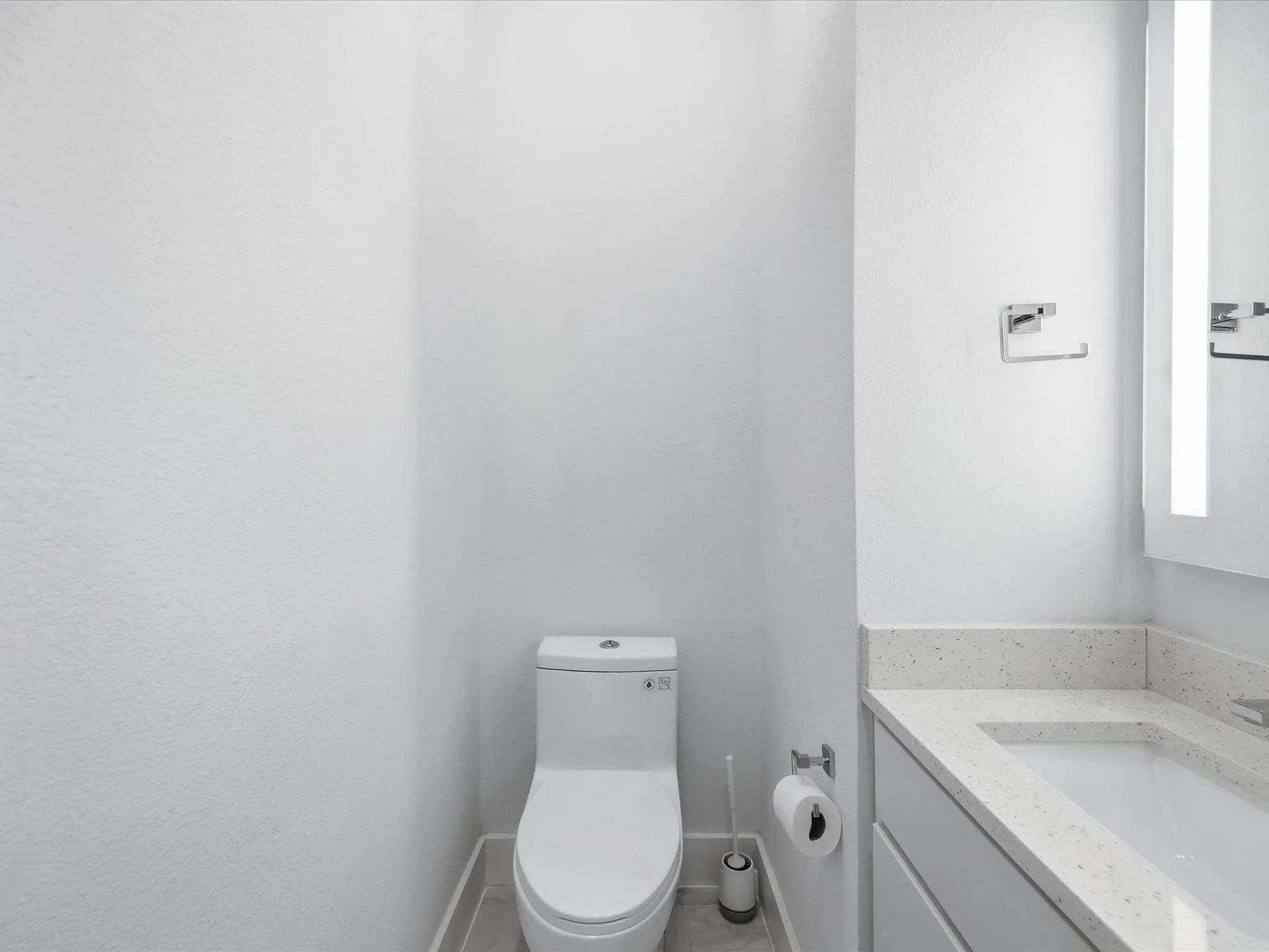 Half bathroom with vanity and toilet