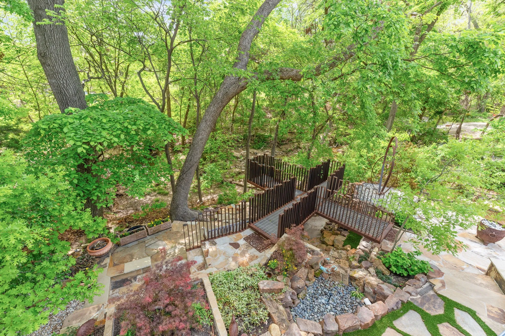 Looking down from patio into your paradise. Metal sculpture has been removed from property.