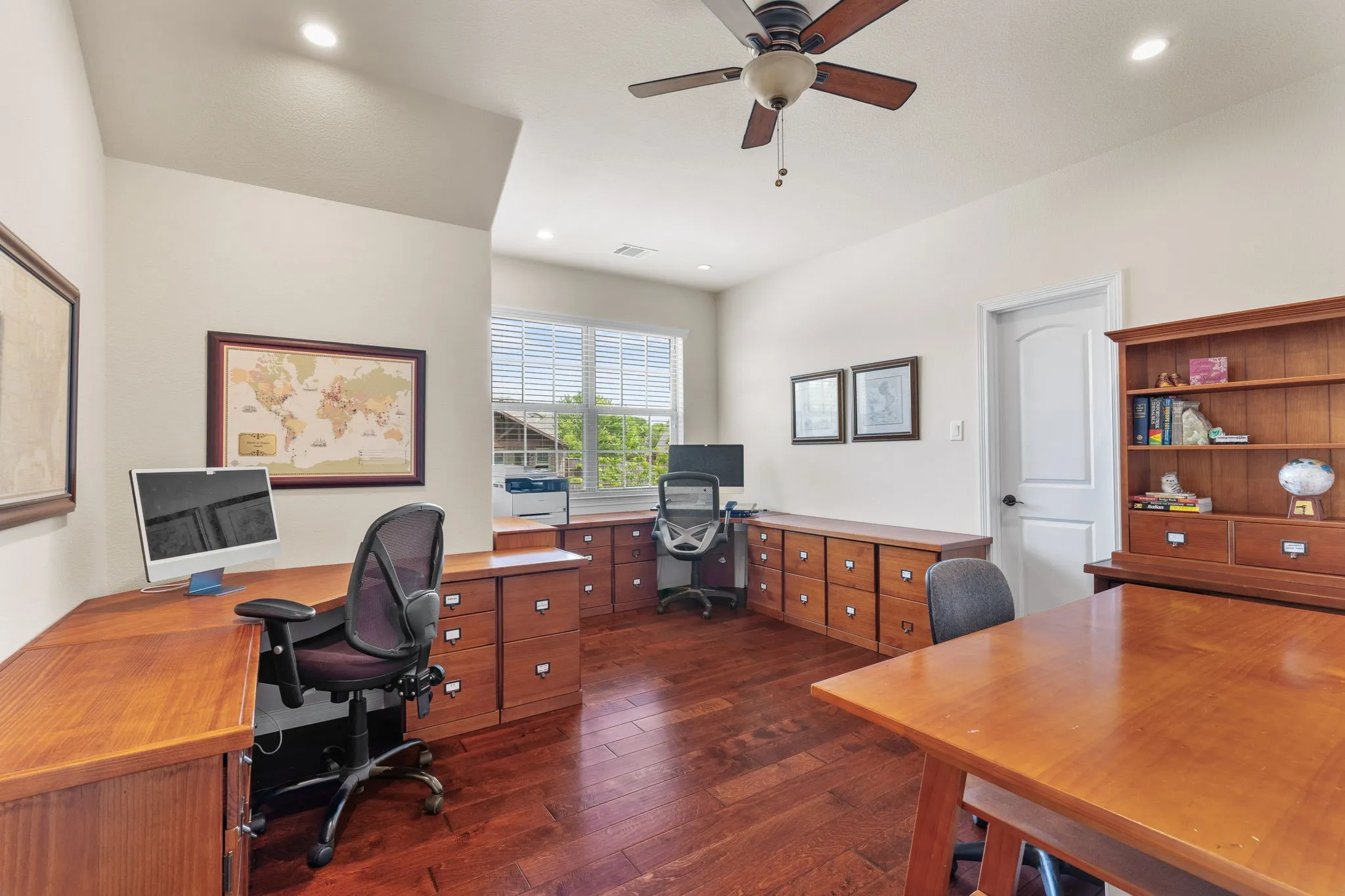 This room with hardwood flooring is being used as an office with a large walk in closet and built in safe that conveys.