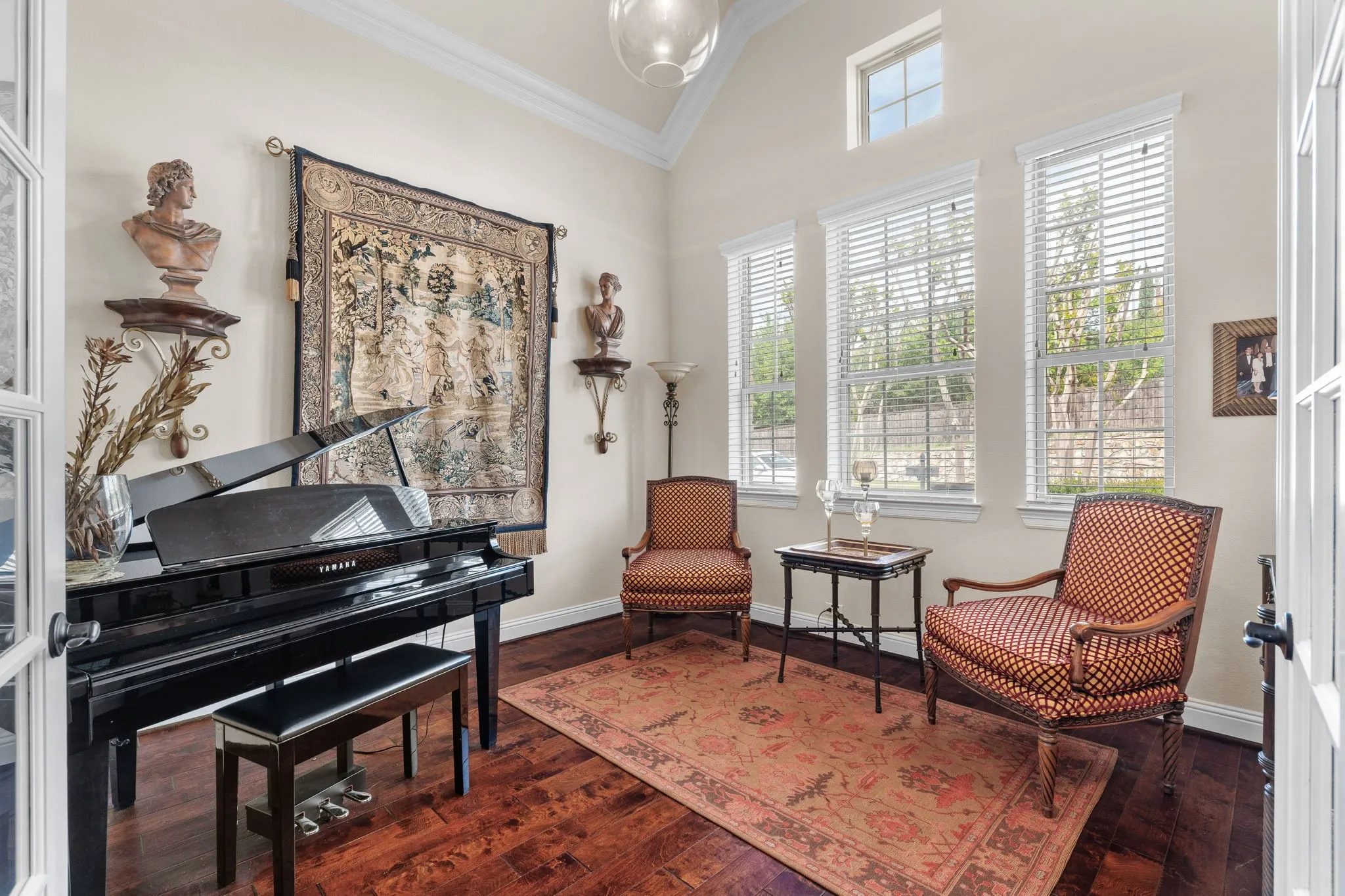 Hardwood floors and vaulted ceiling in this room, that can be your home office. Crown Molding & Updated lighting.