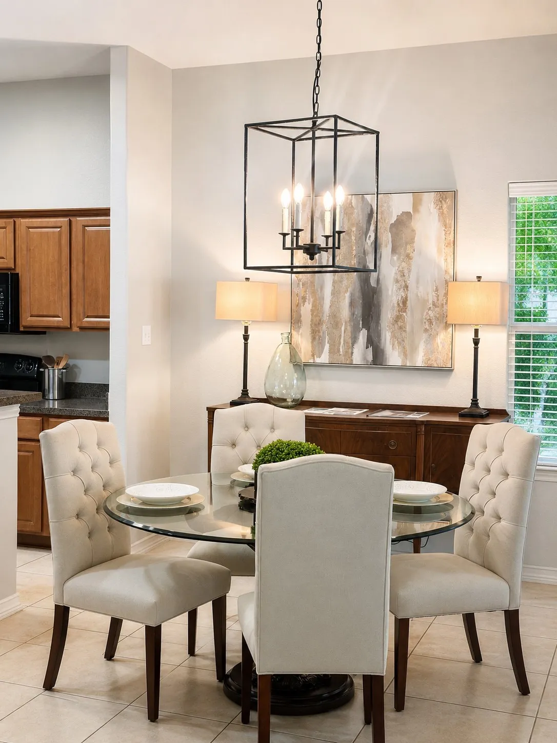 Dining area featuring a modern geometric chandelier, tiled flooring, a glass-top table, and a built-in window