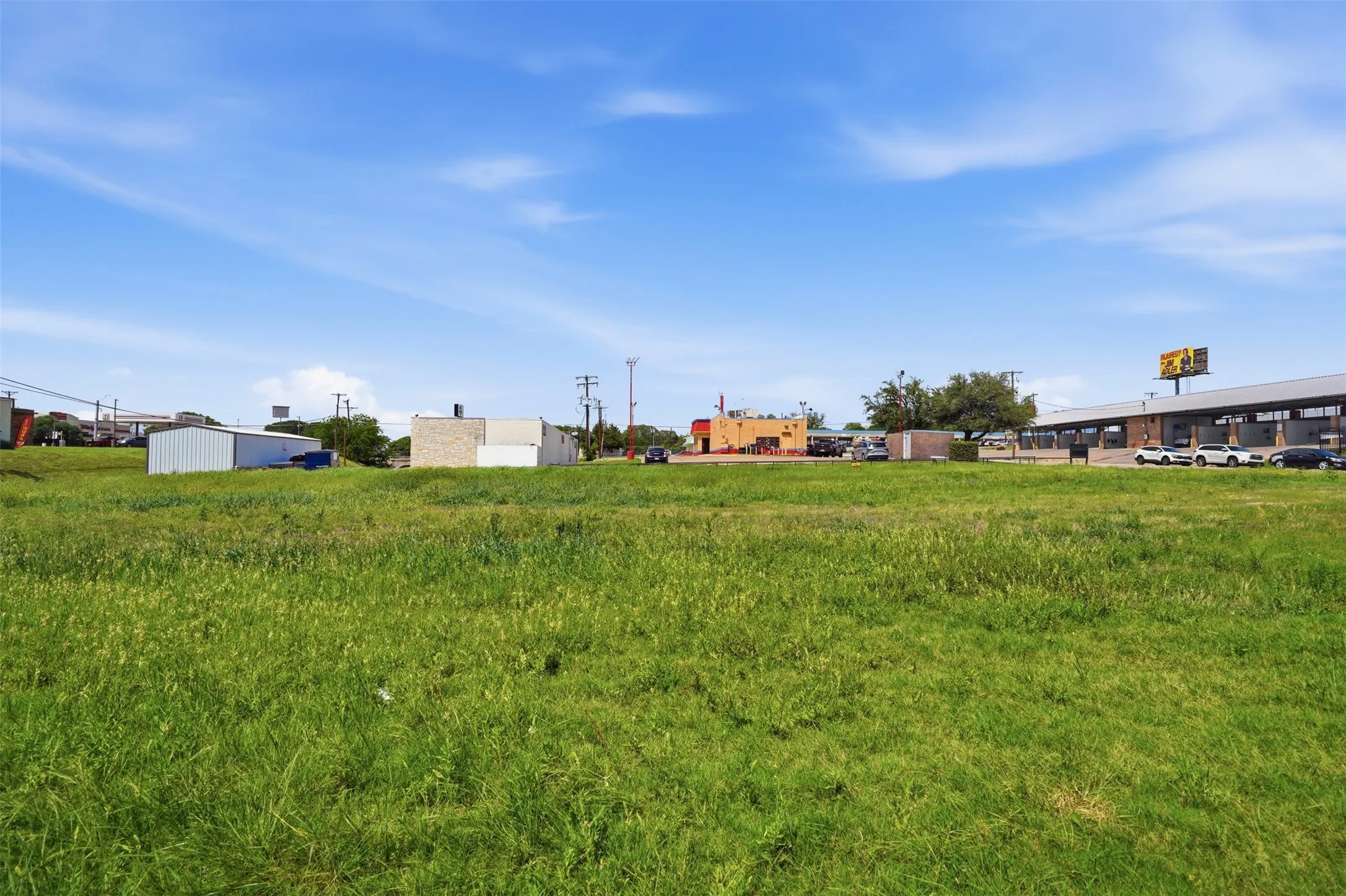 Expansive green space featuring a clear sky overhead